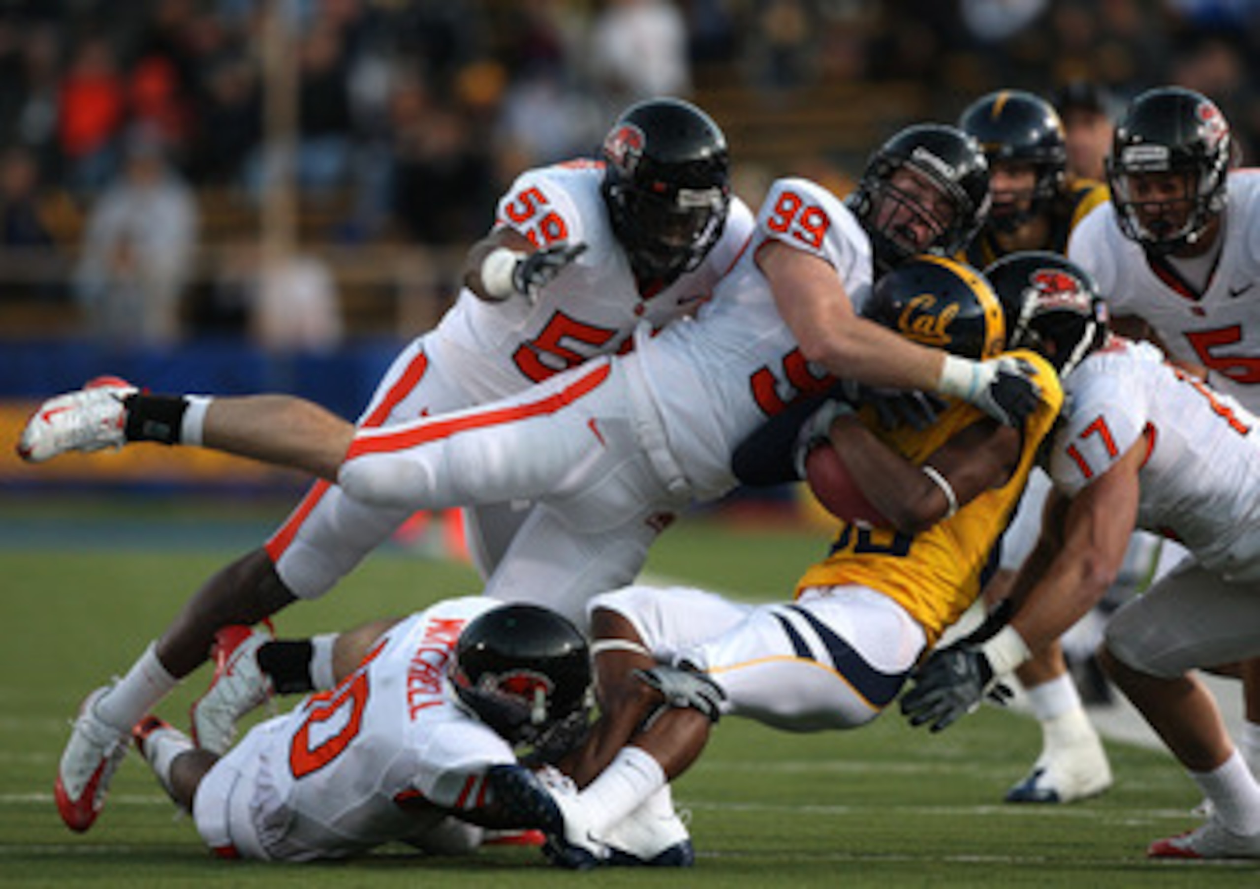 BERKELEY, CA - NOVEMBER 07:  Verran Tucker #86 of the California Golden Bears is tackled by Gabe Miller #99 of the Oregon State Beavers at California Memorial Stadium on November 7, 2009 in Berkeley, California.  (Photo by Jed Jacobsohn/Getty Images)