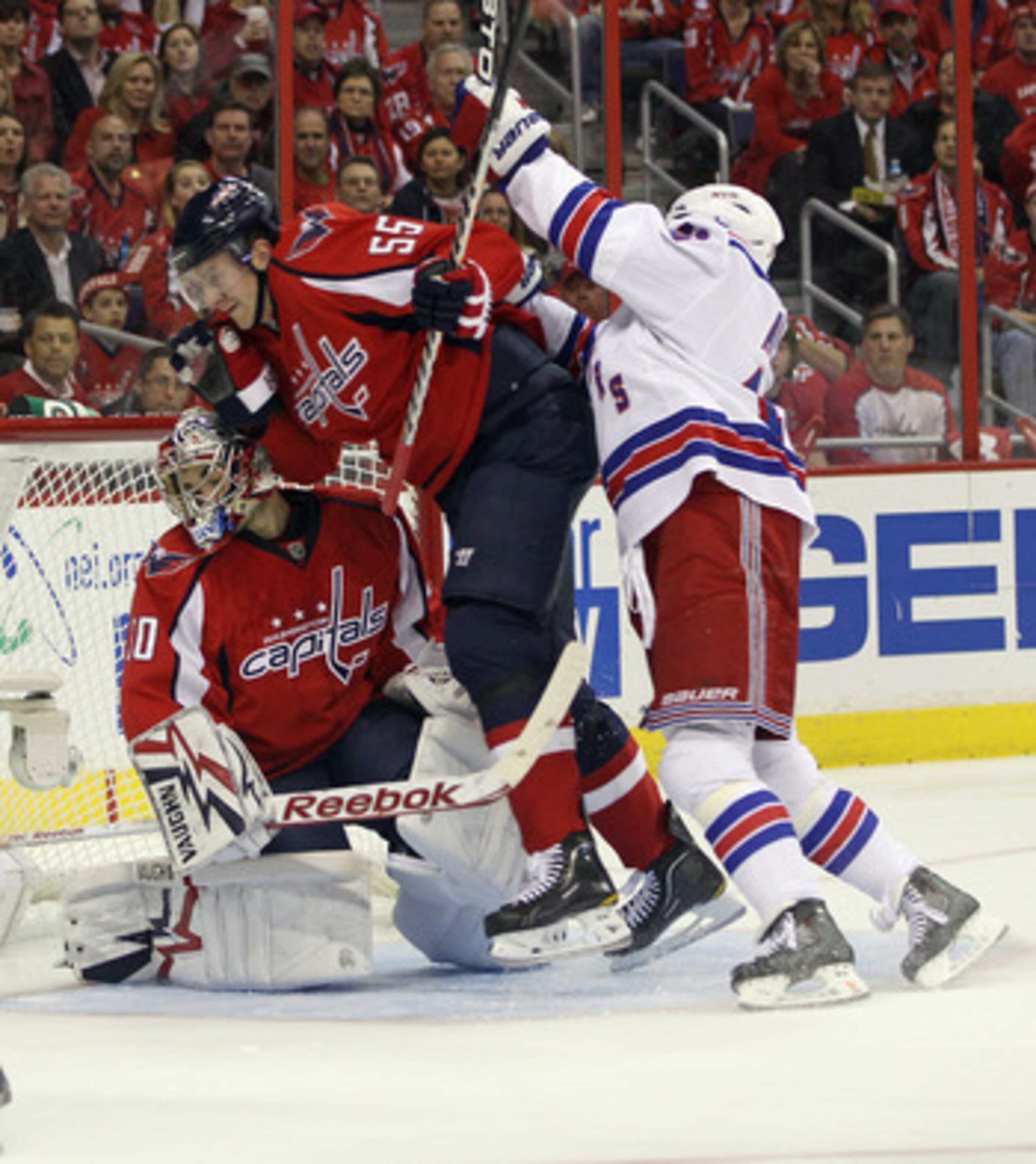 WASHINGTON, DC - APRIL 15: Sean Avery #16 of the New York Rangers pushes Jeff Schultz #55 of the Washington Capitals into goaltender Michal Neuvirth #30 in Game Two of the Eastern Conference Quarterfinals during the 2011 NHL Stanley Cup Playoffs at Verizo
