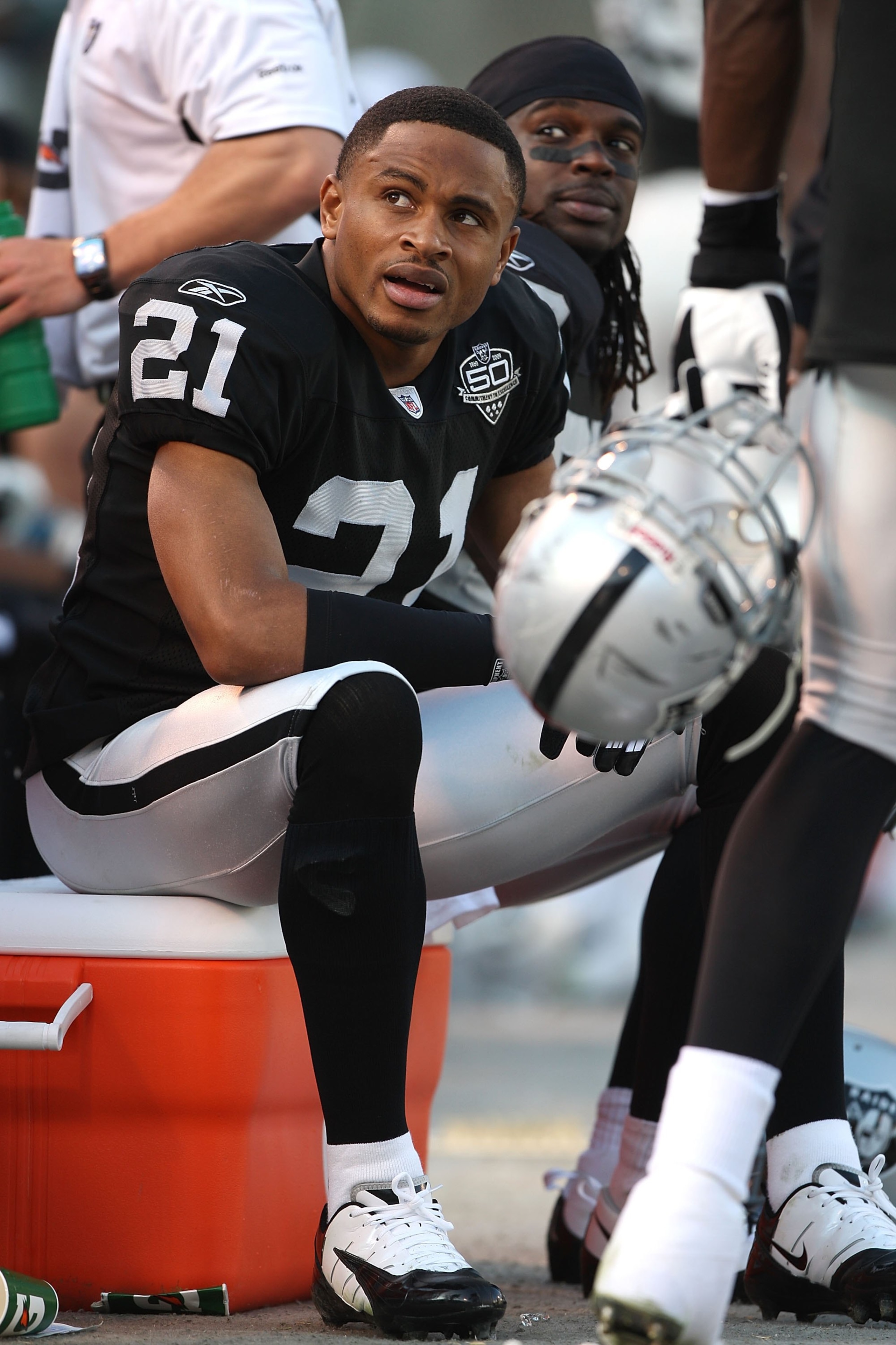 OAKLAND, CA - JANUARY 03:  Nnamdi Asomugha #21 of the Oakland Raiders sits on the bench against the Baltimore Ravens during an NFL game at Oakland-Alameda County Coliseum on January 3, 2010 in Oakland, California.  (Photo by Jed Jacobsohn/Getty Images)