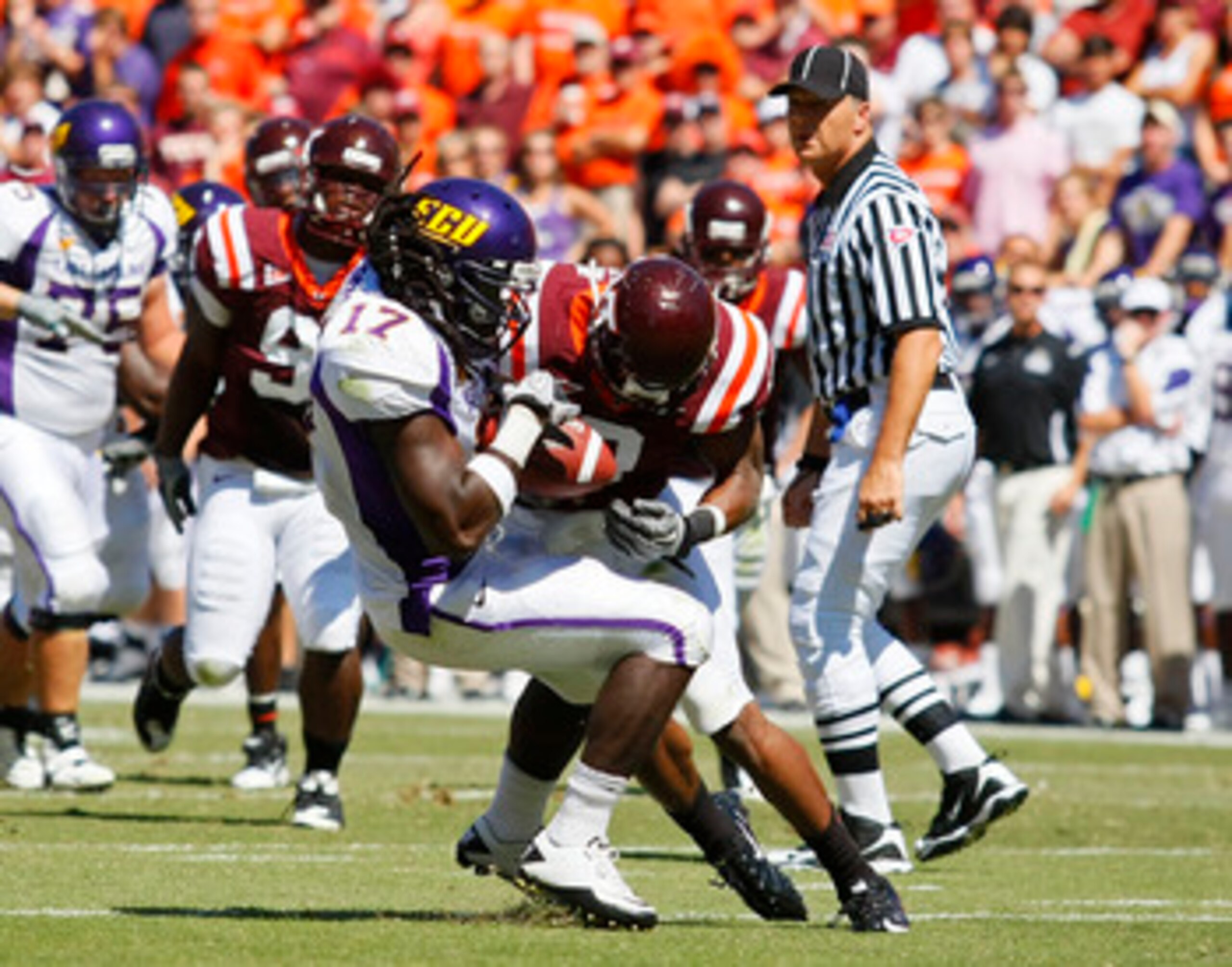 BLACKSBURG, VA - SEPTEMBER 18: Wide receiver Dwayne Harris #17 of the East Carolina Pirates is tackled by linebacker Davon Morgan #2 of the Virginia Tech Hokies at Lane Stadium on September 18, 2010 in Blacksburg, Virginia.  (Photo by Geoff Burke/Getty Im