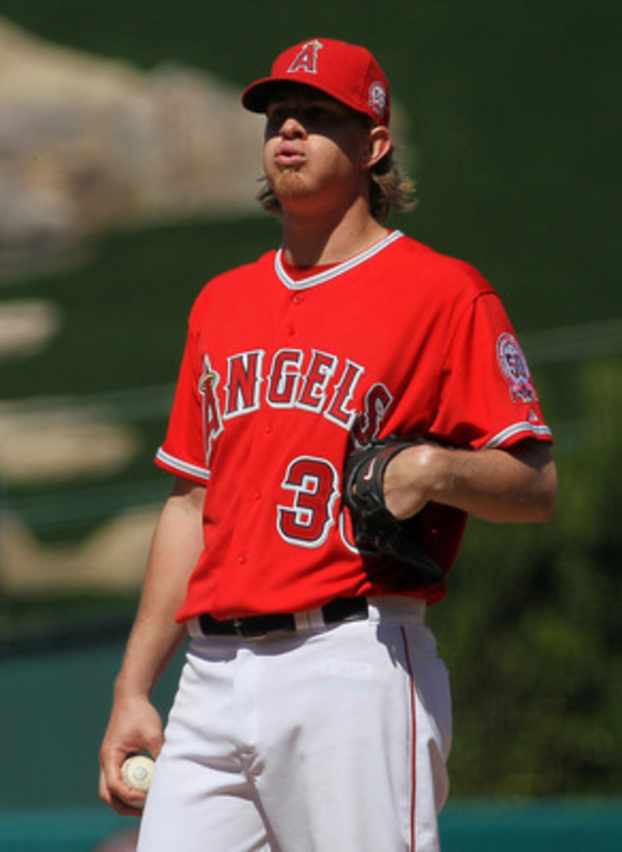 ANAHEIM, CA - APRIL 10:  Jered Weaver #36 of the Los Angeles Angels of Anaheim reacts on the mound as he waits to be relieved in the eighth inning after recording his 15th strikeout against the Toronto Blue Jays on April 10, 2011 at Angel Stadium in Anahe
