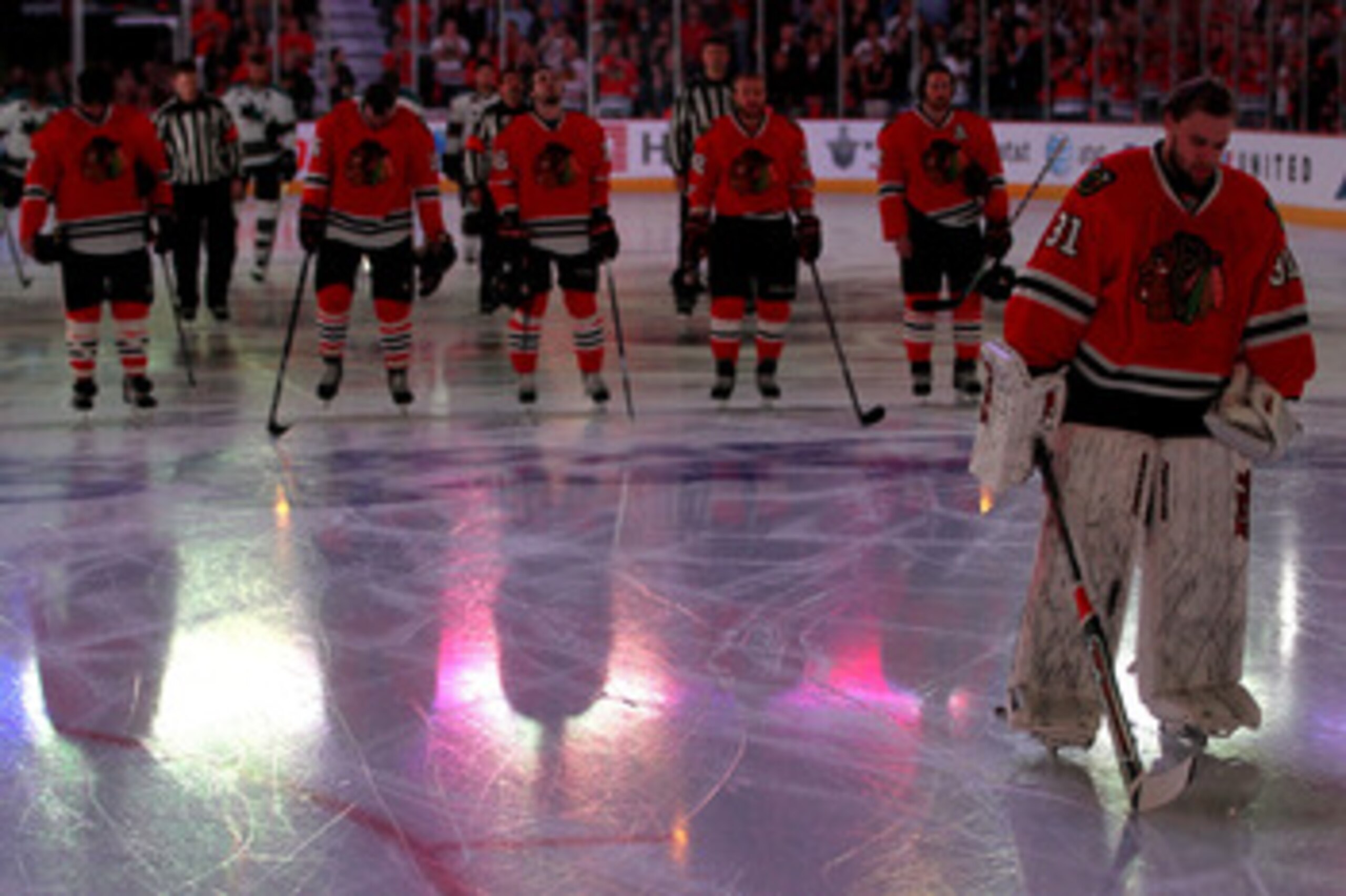 CHICAGO - MAY 21:  (R) Goaltender Antti Niemi #31 of the Chicago Blackhawks stands in front of his teammates during the singing of the national anthem before the Blackhawks take on the San Jose Sharks in Game Three of the Western Conference Finals during 
