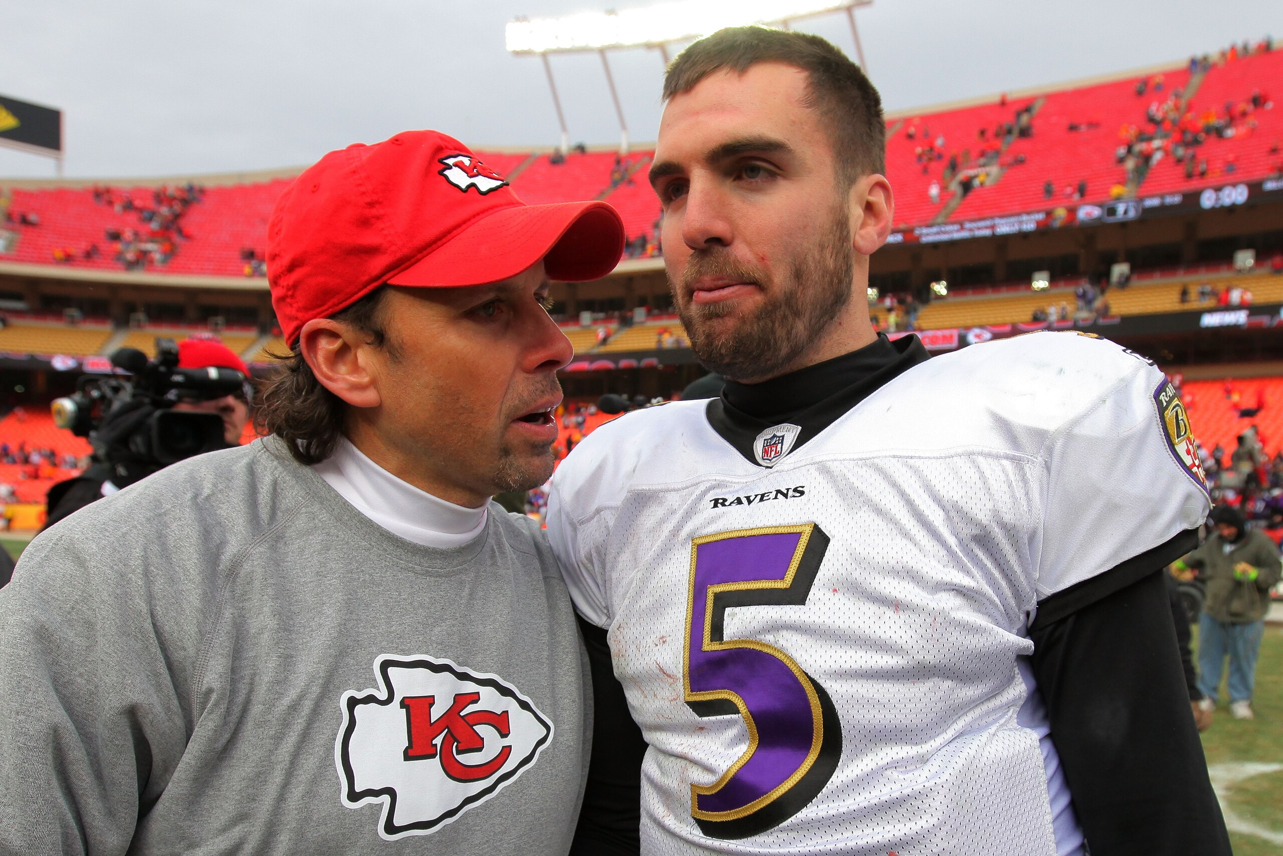 KANSAS CITY, MO - JANUARY 09:  Head coach Todd Haley of the Kansas City Chiefs and quarterback Joe Flacco #5 of the Baltimore Ravens speak to each other on the field after the Ravens defeated the Chiefs 30-7 in the 2011 AFC wild card playoff game at Arrow