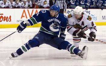 VANCOUVER, CANADA - APRIL 26: Duncan Keith #2 of the Chicago Blackhawks hauls down Alexandre Burrows #14 of the Vancouver Canucks during the third period in Game Seven of the Western Conference Quarterfinals during the 2011 NHL Stanley Cup Playoffs on Apr