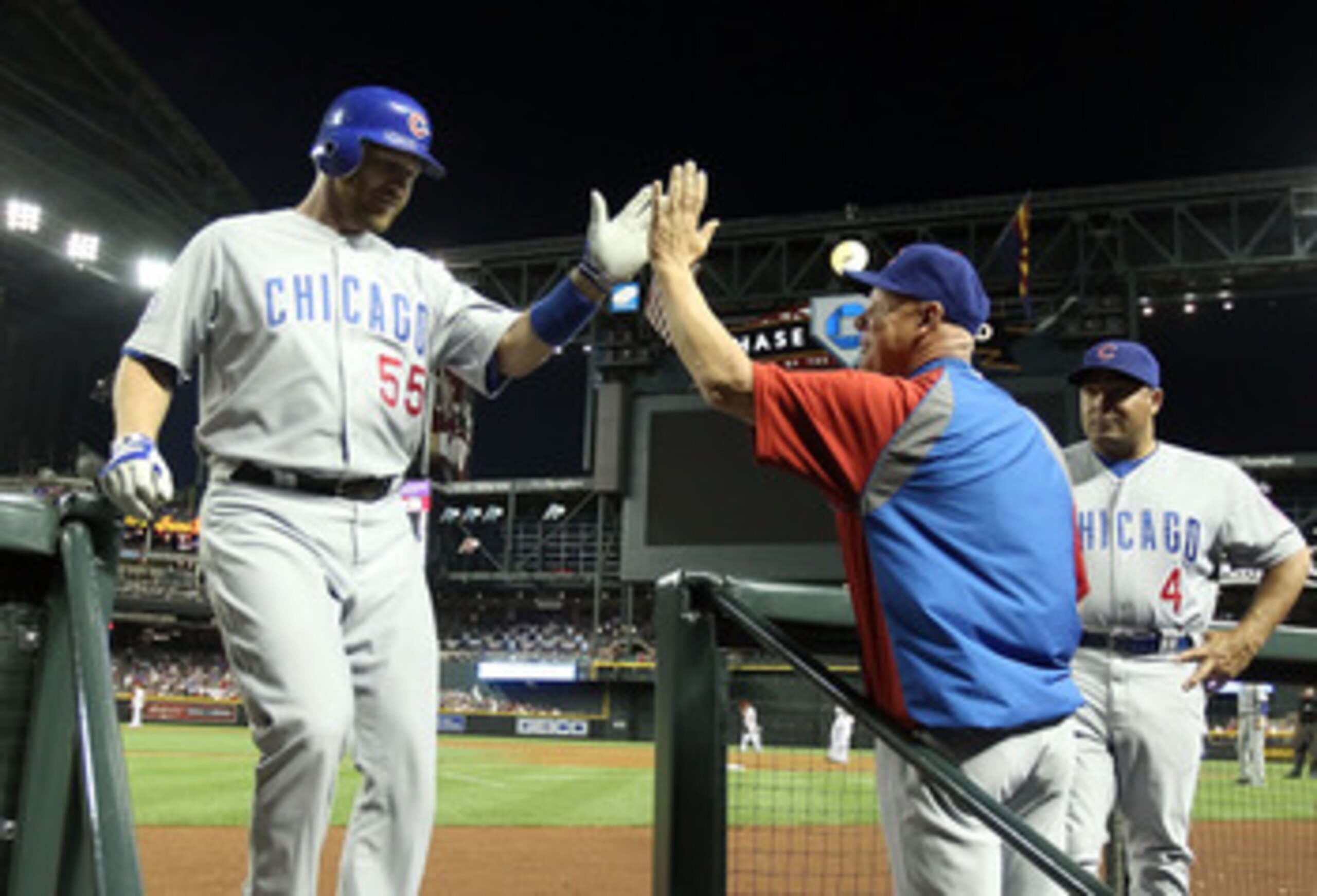 PHOENIX, AZ - APRIL 28:  Koyie Hill #55 of the Chicago Cubs high fives manager Mike Quade after Hill hit a solo home run against the Arizona Diamondbacks during the third inning of the Major League Baseball game at Chase Field on April 28, 2011 in Phoenix
