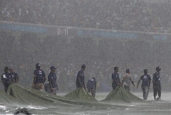 COLOMBO, SRI LANKA - MARCH 05:  Ground staff attempt to cover the outfield as heavy rain halts play during the Australia v Sri Lanka 2011 ICC World Cup Group A match at the R. Premadasa Stadium on March 5, 2011 in Colombo, Sri Lanka.  (Photo by Michael St