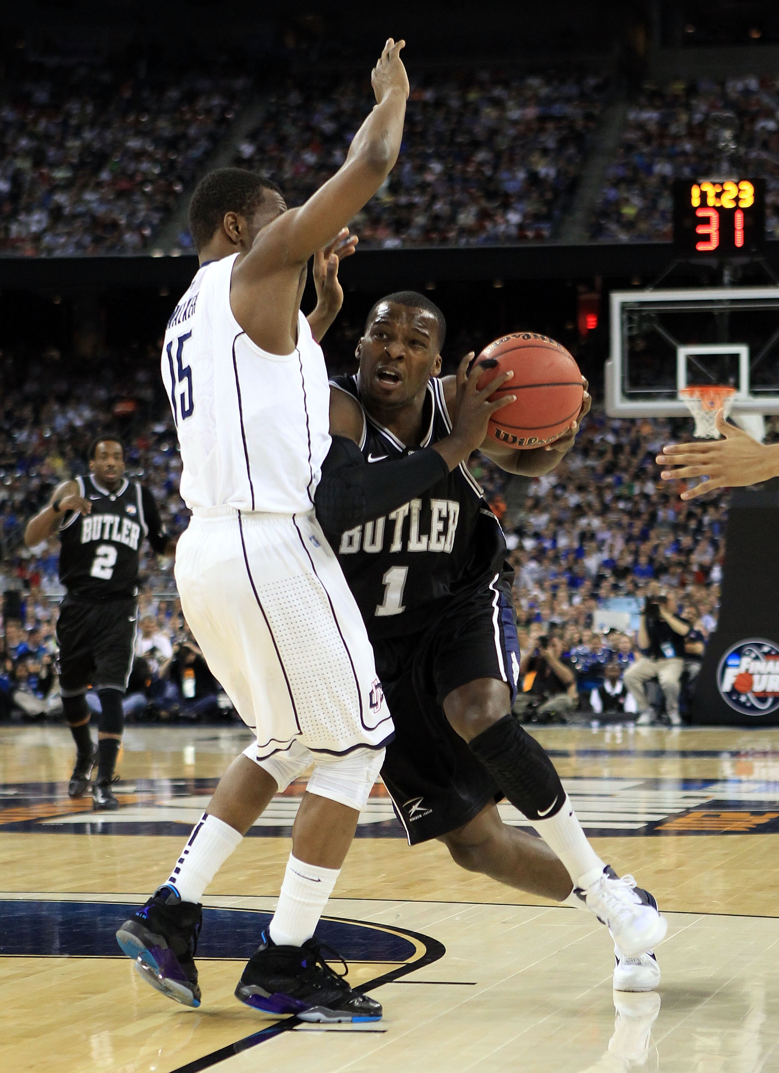HOUSTON, TX - APRIL 04:  Shelvin Mack #1 of the Butler Bulldogs drives on Kemba Walker #15 of the Connecticut Huskies during the National Championship Game of the 2011 NCAA Division I Men's Basketball Tournament at Reliant Stadium on April 4, 2011 in Hous