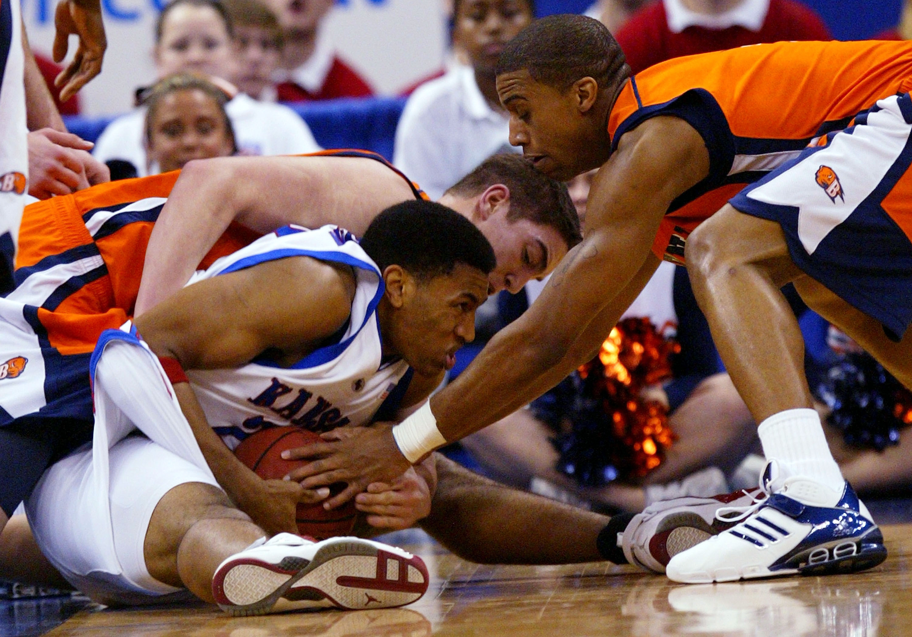 OKLAHOMA CITY - MARCH 18:  Wayne Simien #23 of the Kansas Jayhawks holds off Chris McNaughton #32 and Charles Lee #3 of the Bucknell Bison in the first round of the NCAA Men's Basketball Championship on March 18, 2005 at the Ford Center in Oklahoma City,