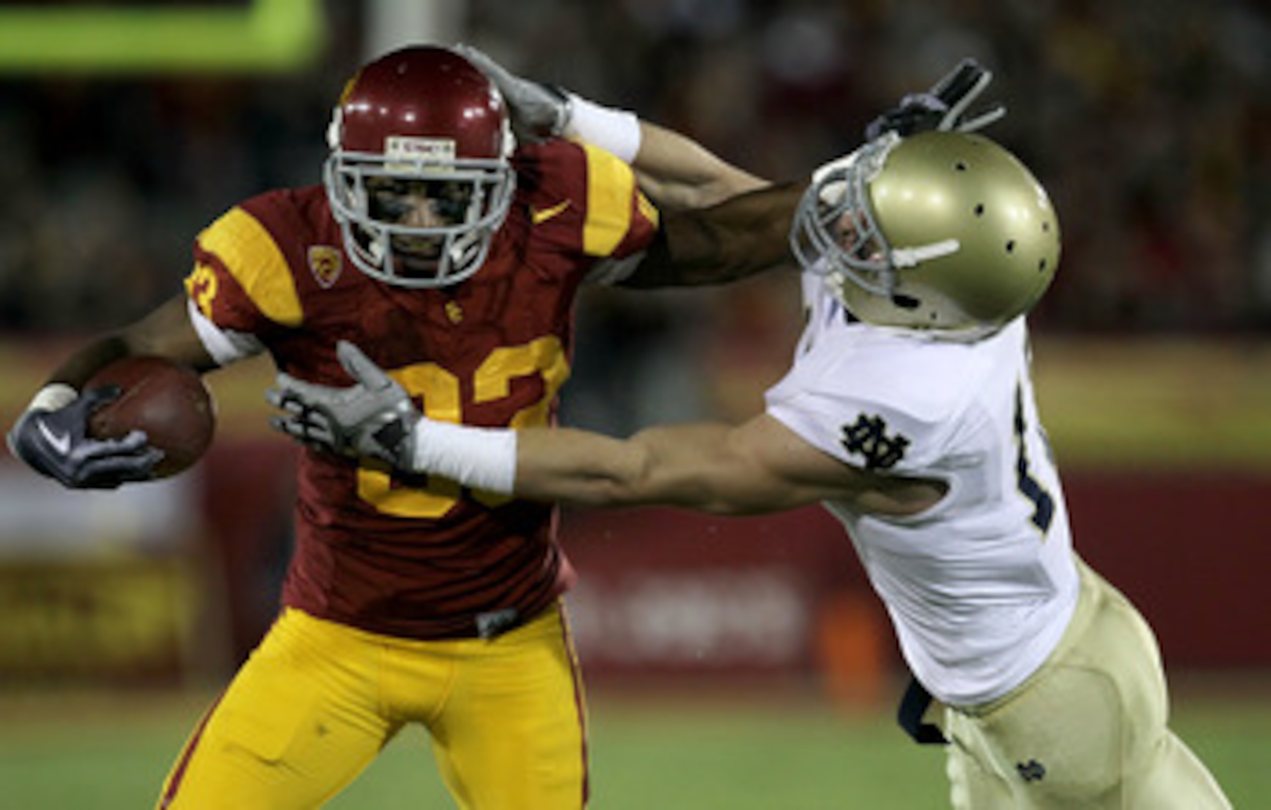 LOS ANGELES - NOVEMBER 27: Wide receiver Ronald Johnson #83 of the USC Trojans carries ball against safety Zeke Motta #17 of the Notre Dame Fighting Irish at the Los Angeles Memorial Coliseum on November 27, 2010 in Los Angeles, California. (Photo by S LOS ANGELES - NOVEMBER 27: Wide receiver Ronald Johnson #83 of the USC Trojans carries ball against safety Zeke Motta #17 of the Notre Dame Fighting Irish at the Los Angeles Memorial Coliseum on November 27, 2010 in Los Angeles, California. (Photo by S