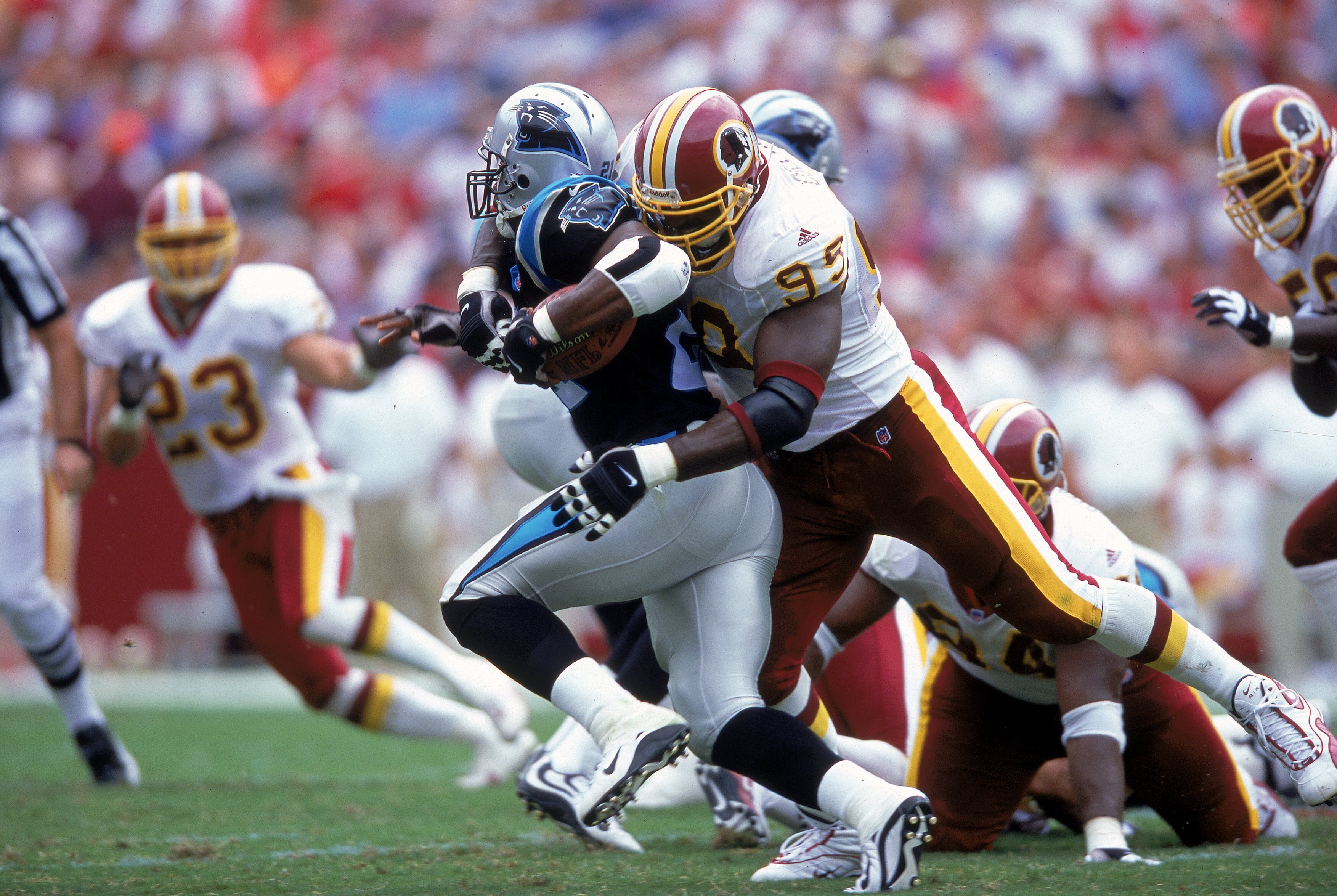 3 Sep 2000: Dan Wilkinson #95 of the Washington Redskins tackles Tshimanga Biakabutuka #21 of the Carolina Panthers at the FedEx Field in Landover, Maryland. The Redskins defeated the Panthers 20-17.Mandatory Credit: Ezra O. Shaw  /Allsport