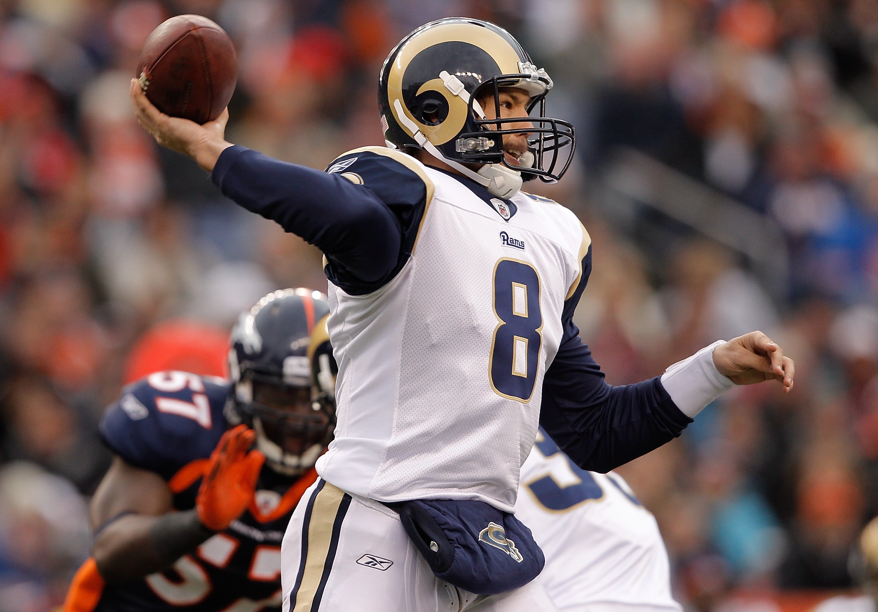 DENVER - NOVEMBER 28:  Quarterback Sam Bradford #8 of the St. Louis Rams makes a pass against the Denver Broncos in the first quarter at INVESCO Field at Mile High on November 28, 2010 in Denver, Colorado. (Photo by Justin Edmonds/Getty Images)