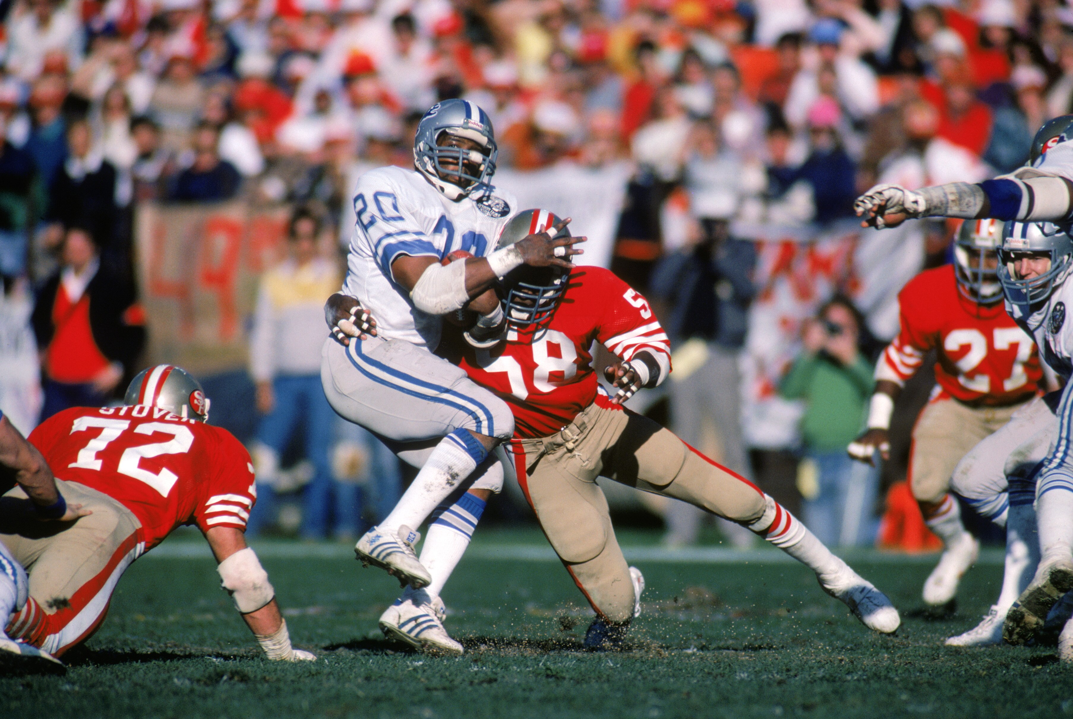 SAN FRANCISCO - 1983:  Running back Billy Sims #20 of the Detroit Lions gets tackled during a game against the San Francisco 49ers in a 1983 NFL season game at Candlestick Park in San Francisco, California.  (Photo by Getty Images)
