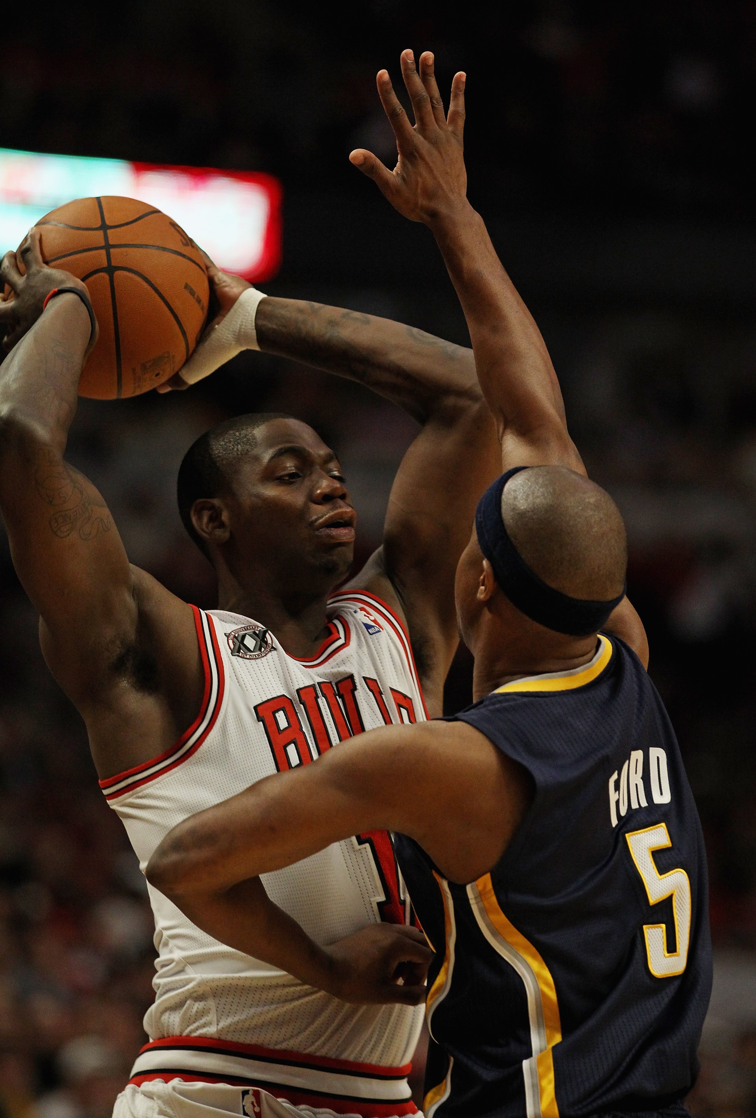 CHICAGO, IL - APRIL 18: Ronnie Brewer #11 of the Chicago Bulls tries to pass over the defense of T.J. Ford #5 of the Indiana Pacers in Game Two of the Eastern Conference Quarterfinals in the 2011 NBA Playoffs at the United Center on April 18, 2011 in Chic
