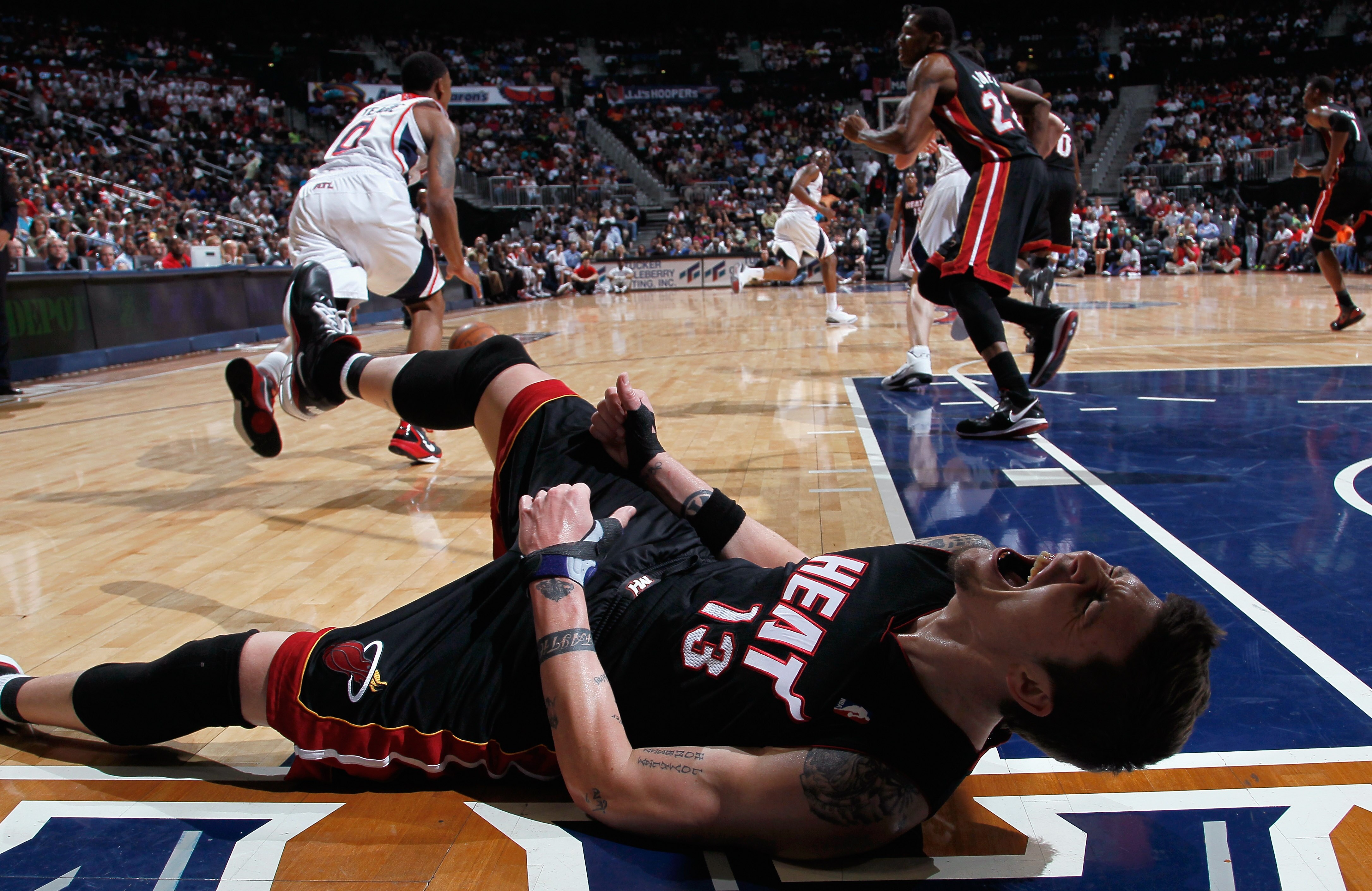 ATLANTA, GA - APRIL 11:  Mike Miller #13 of the Miami Heat reacts after battling for a loose ball against the Atlanta Hawks at Philips Arena on April 11, 2011 in Atlanta, Georgia.  NOTE TO USER: User expressly acknowledges and agrees that, by downloading 