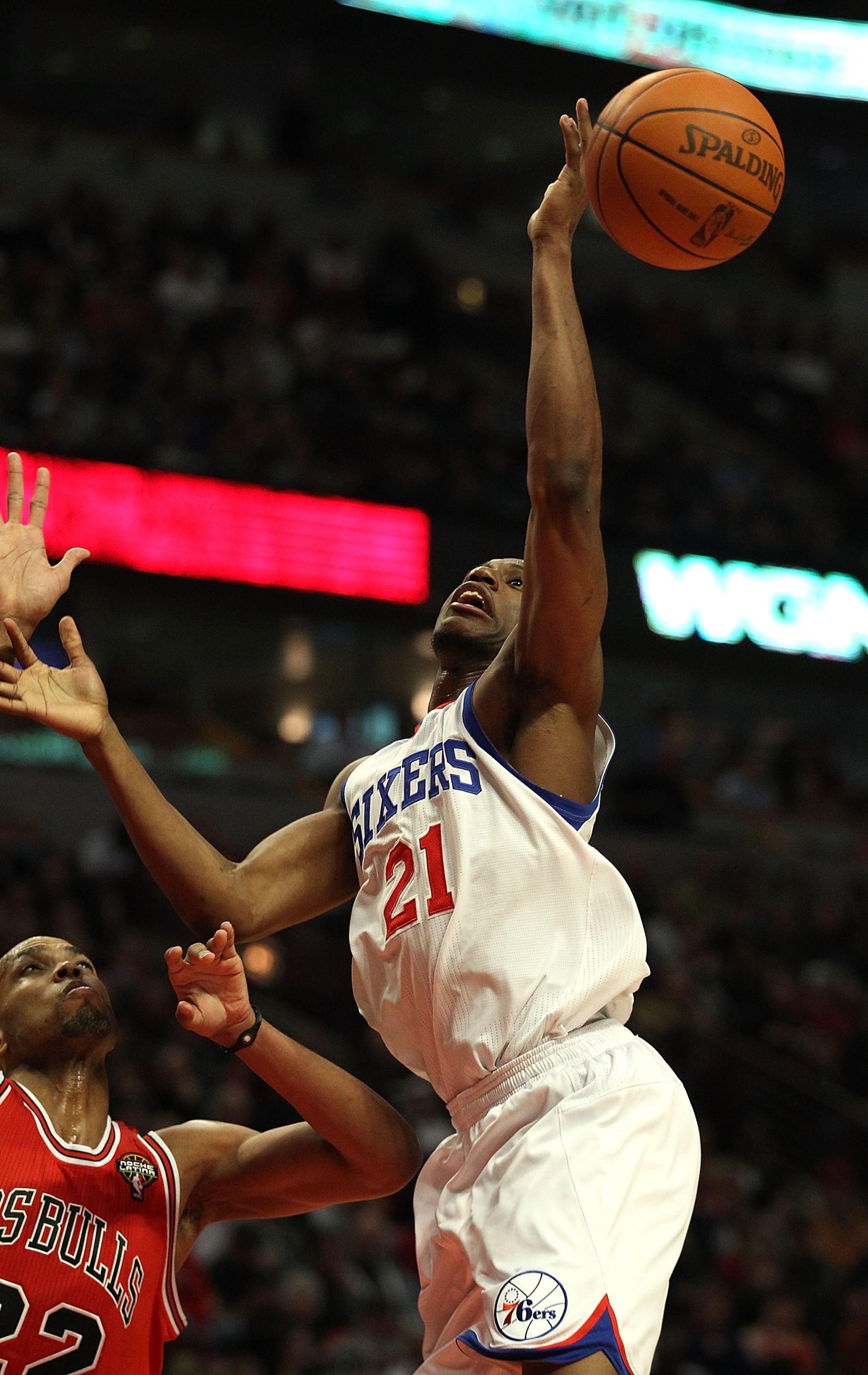CHICAGO, IL - MARCH 28: Thaddeus Young #21 of the Philadelphia 76ers looses control of the ball going up for a shot against Taj Gibson #22 of the Chicago Bulls at the United Center on March 28, 2011 in Chicago, Illinois. NOTE TO USER: User expressly ackno