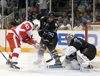 SAN JOSE, CA - APRIL 29:  Niclas Wallin #7 and Antti Niemi #31 of the San Jose Sharks stop Darren Helm #43 of the Detroit Red Wings in Game One of the Western Conference Semifinals during the 2011 NHL Stanley Cup Playoffs at HP Pavilion on April 29, 2011