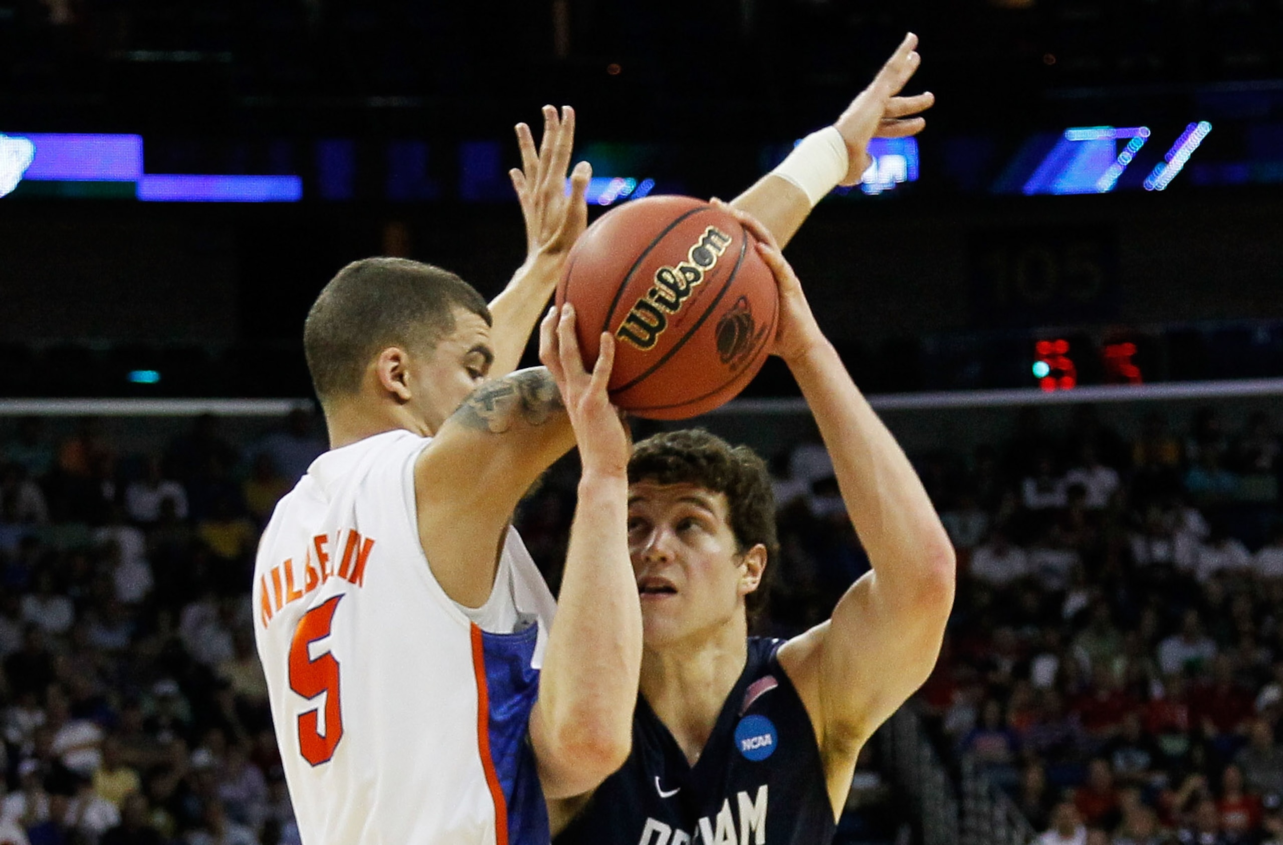 NEW ORLEANS, LA - MARCH 24:  Jimmer Fredette #32 of the Brigham Young Cougars goes up against Scottie Wilbekin #5 of the Florida Gators during the Southeast regional of the 2011 NCAA men's basketball tournament at New Orleans Arena on March 24, 2011 in Ne