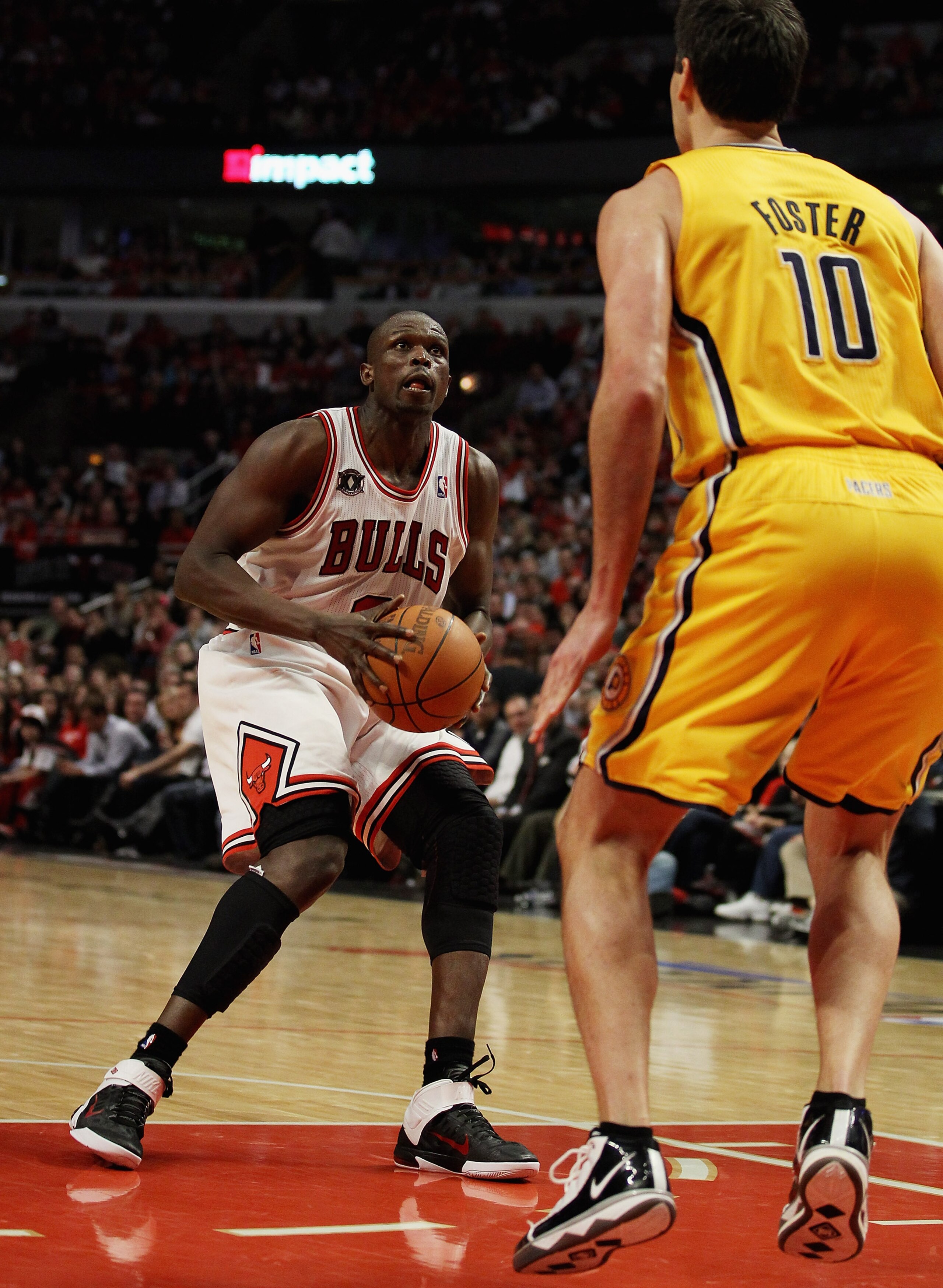 CHICAGO, IL - APRIL 26: Loul Deng #9 of the Chicago Bulls prepares to shoot against Jeff Foster #10 of the Indiana Pacers in Game Five of the Eastern Conference Quarterfinals in the 2011 NBA Playoffs at the United Center on April 26, 2011 in Chicago, Illi