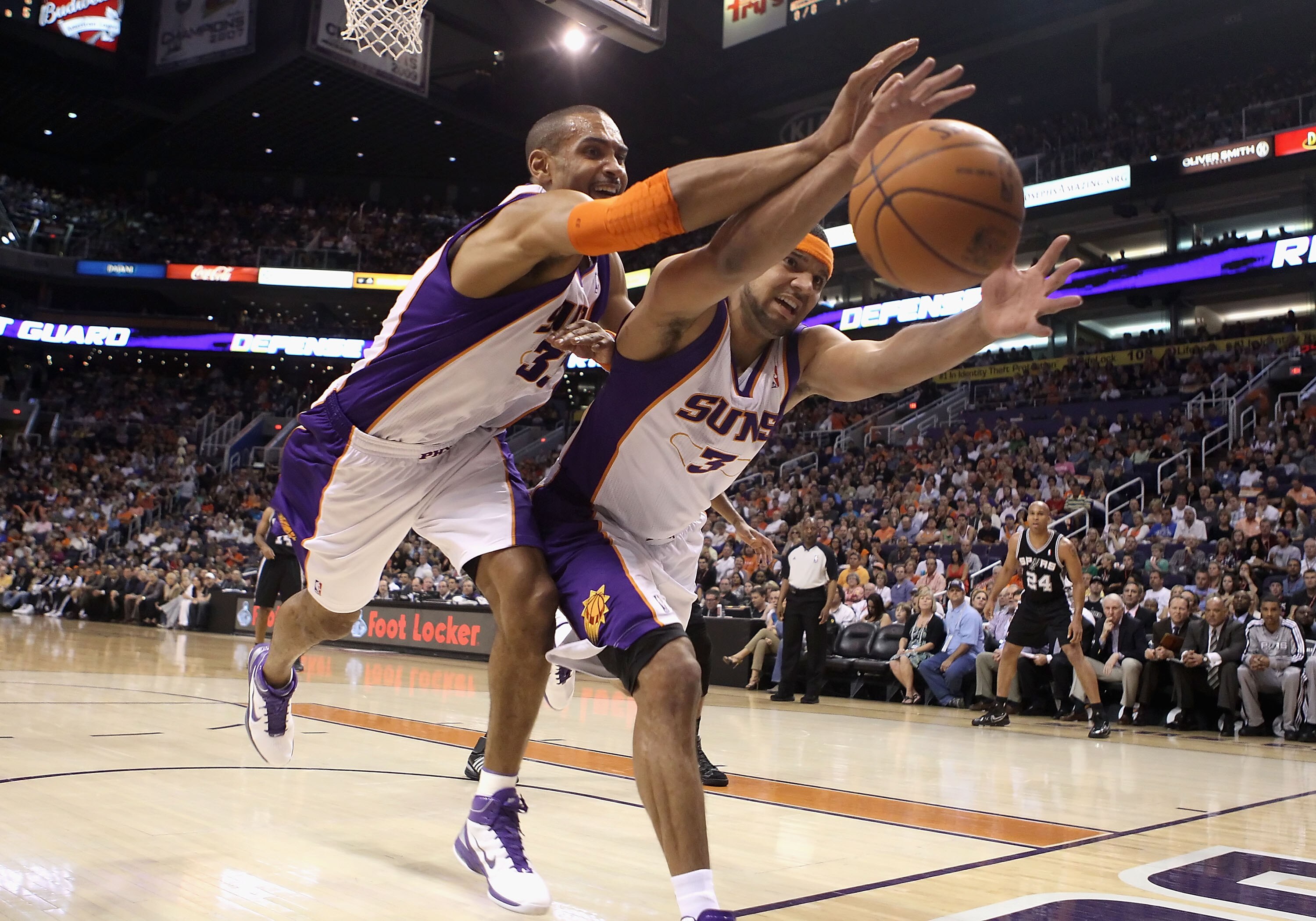 PHOENIX, AZ - APRIL 13:  Grant Hill #33 and Jared Dudley #3 of the Phoenix Suns reach for a loose ball during the NBA game against the San Antonio Spurs at US Airways Center on April 13, 2011 in Phoenix, Arizona.  NOTE TO USER: User expressly acknowledges