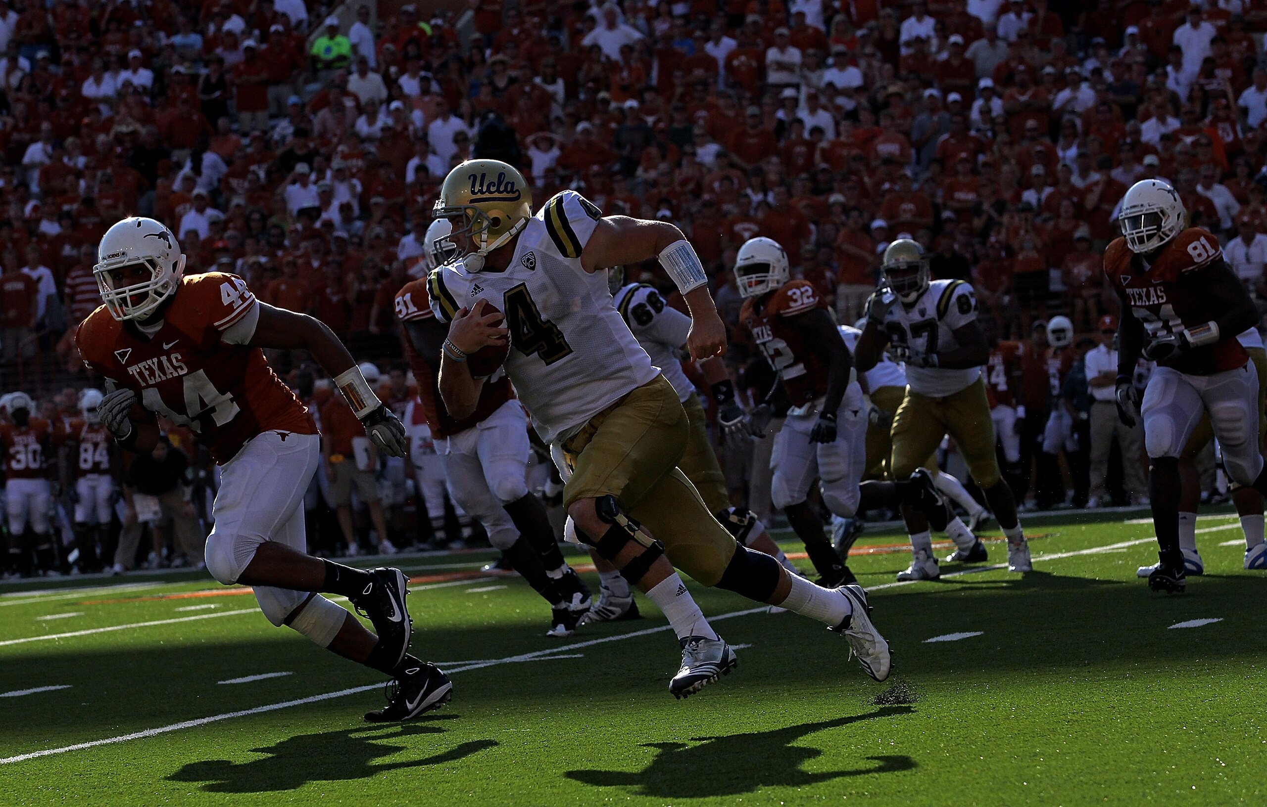 AUSTIN, TX - SEPTEMBER 25:  Quarterback Kevin Prince #4 of the UCLA Bruins runs the ball past Jackson Jeffcoat #44 of the Texas Longhorns at Darrell K Royal-Texas Memorial Stadium on September 25, 2010 in Austin, Texas.  (Photo by Ronald Martinez/Getty Im