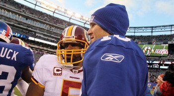 EAST RUTHERFORD, NJ - DECEMBER 05: Donovan McNabb #5 of the Washington Redskins meets with Eli Manning #10 of the New York Giants after their game on December 5, 2010 at the New Meadowlands Stadium in East Rutherford, New Jersey. The Giants defeated the R