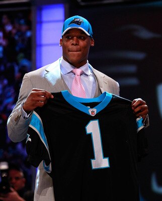 NEW YORK, NY - APRIL 28:  Cam Newton, #1 overall pick by the Carolina Panthers holds up a jersey on stage after he was picked during the 2011 NFL Draft at Radio City Music Hall on April 28, 2011 in New York City.  (Photo by Chris Trotman/Getty Images)