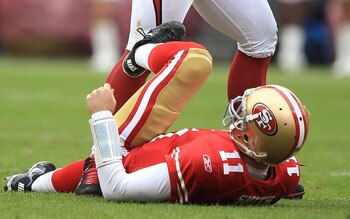SAN FRANCISCO, CA - JANUARY 02:    Alex Smith #11 of the San Francisco 49ers is sacked by Darnell Dockett #90 of the Arizona Cardinals during an NFL game at Candlestick Park on January 2, 2011 in San Francisco, California.  (Photo by Jed Jacobsohn/Getty I