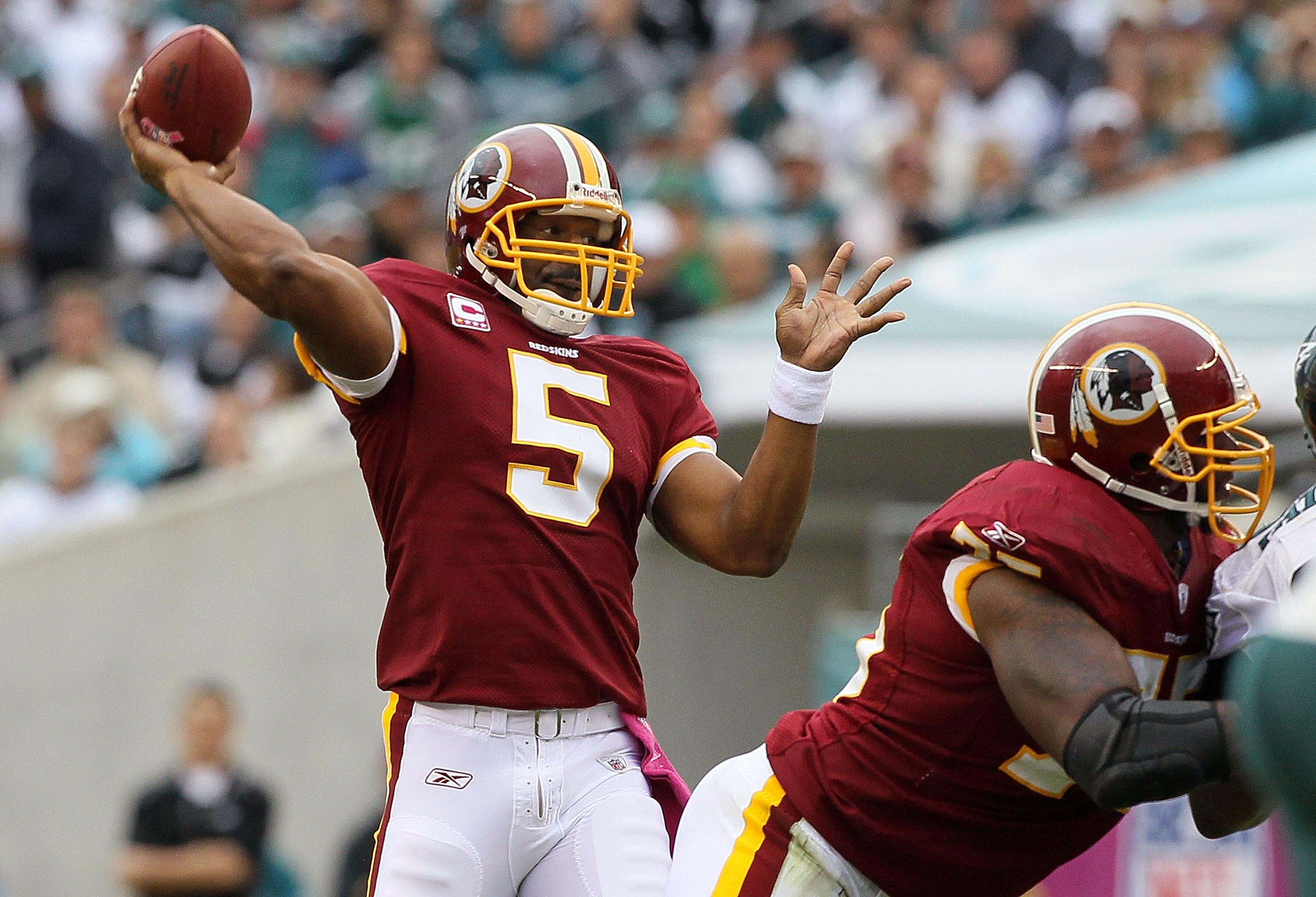 PHILADELPHIA - OCTOBER 03:  Donovan McNabb #5 of the Washington Redskins throws a first quater touchdown pass against the Philadelphia Eagles to teammate Chris Cooley (not pictured) on October 3, 2010 at Lincoln Financial Field in Philadelphia, Pennsylvan