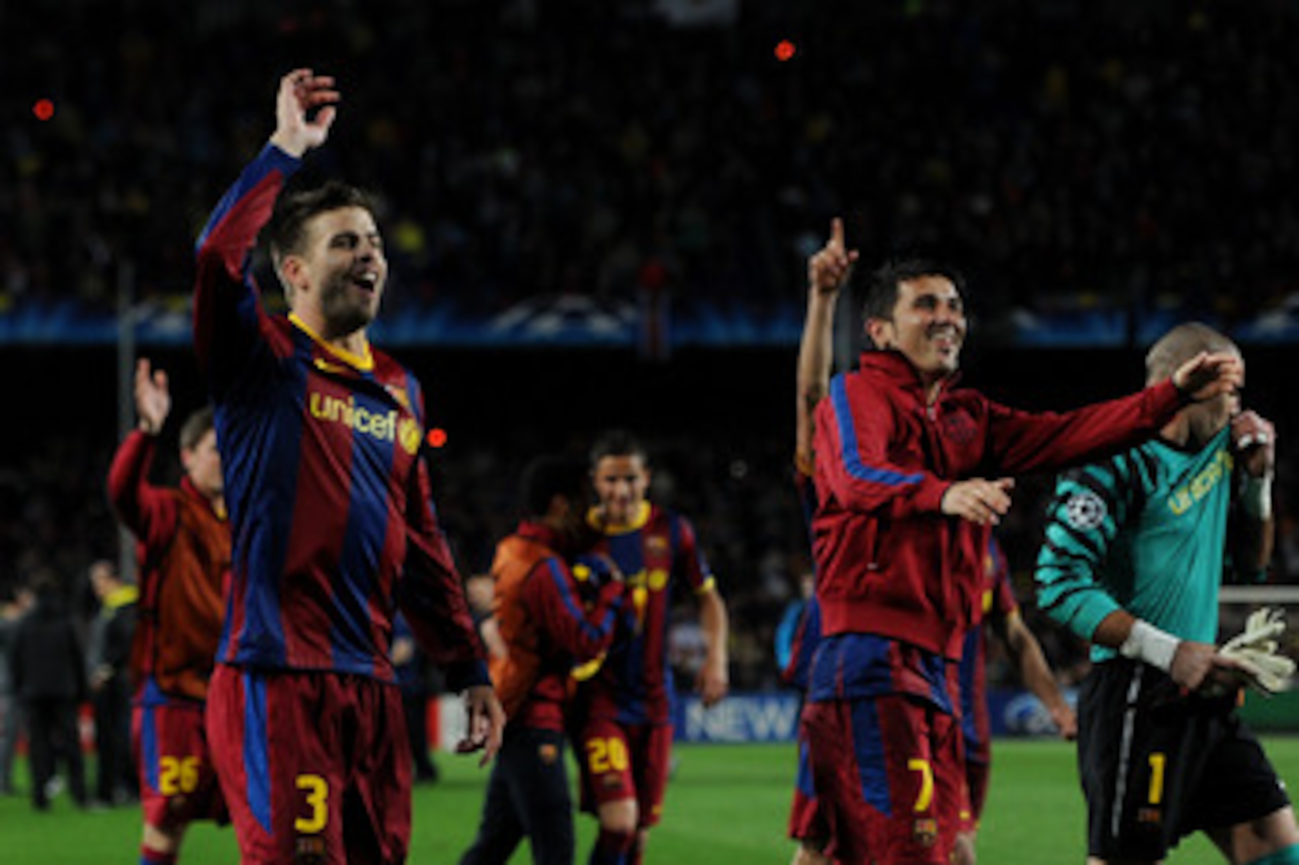 BARCELONA, SPAIN - MAY 03:  Gerard Pique (L) and David Villa of Barcelona celebrate with their teammates at the end of the UEFA Champions League Semi Final second leg match between Barcelona and Real Madrid at the Camp Nou stadium on May 3, 2011 in Barcel