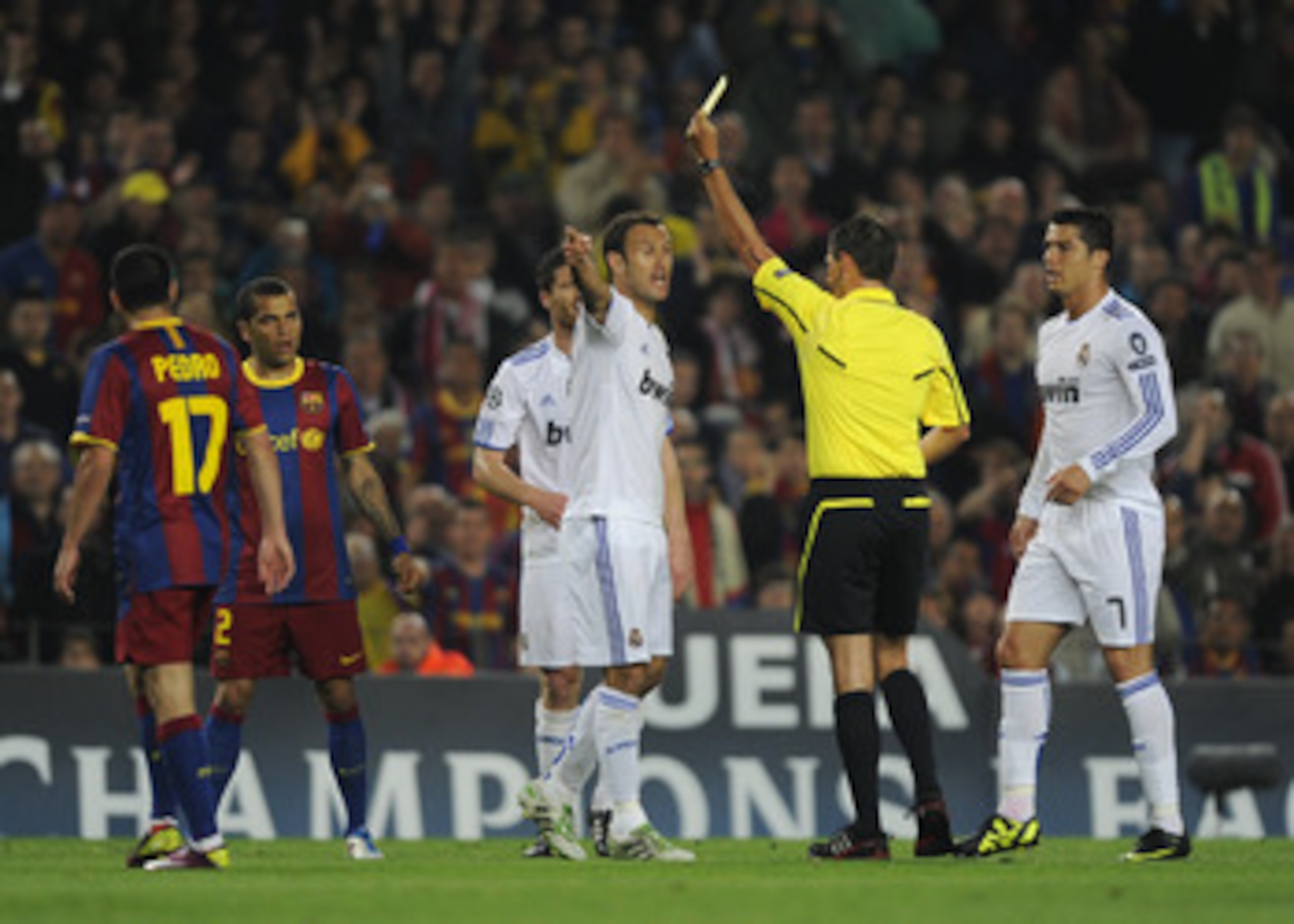 BARCELONA, SPAIN - MAY 03:  Referee Frank De Bleeckere shows the yellow card to Carvalho of Real Madrid (C) during the UEFA Champions League Semi Final second leg match between Barcelona and Real Madrid at the Nou Camp on May 3, 2011 in Barcelona, Spain.