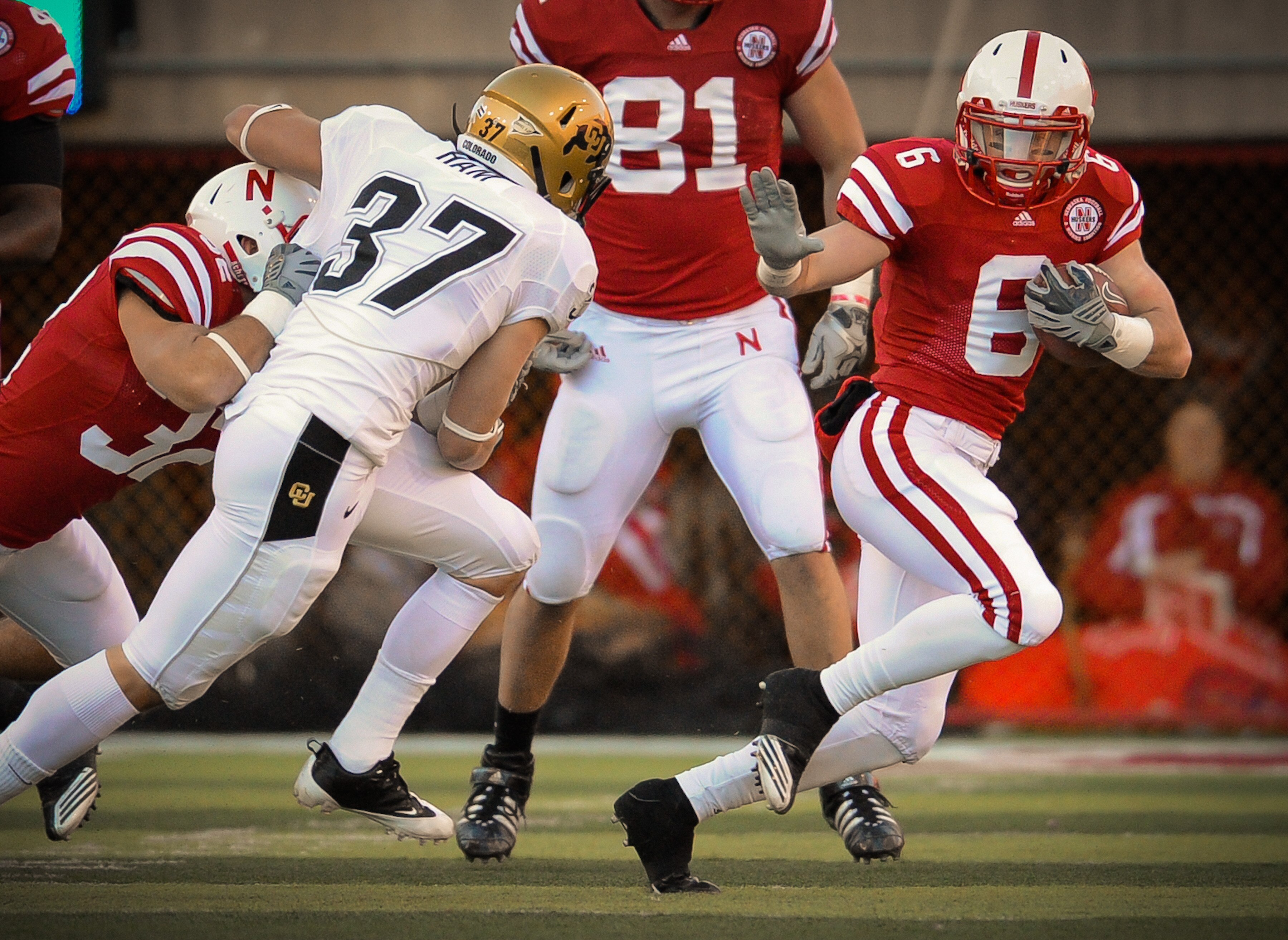 LINCOLN, NE - NOVEMBER 26: Tim Marlowe #6 of the Nebraska Cornhuskers slips past Cameron Ham #37 of the Colorado Buffaloes during their game at Memorial Stadium on November 26, 2010 in Lincoln, Nebraska. Nebraska defeated Colorado 45-17 (Photo by Eric Fra