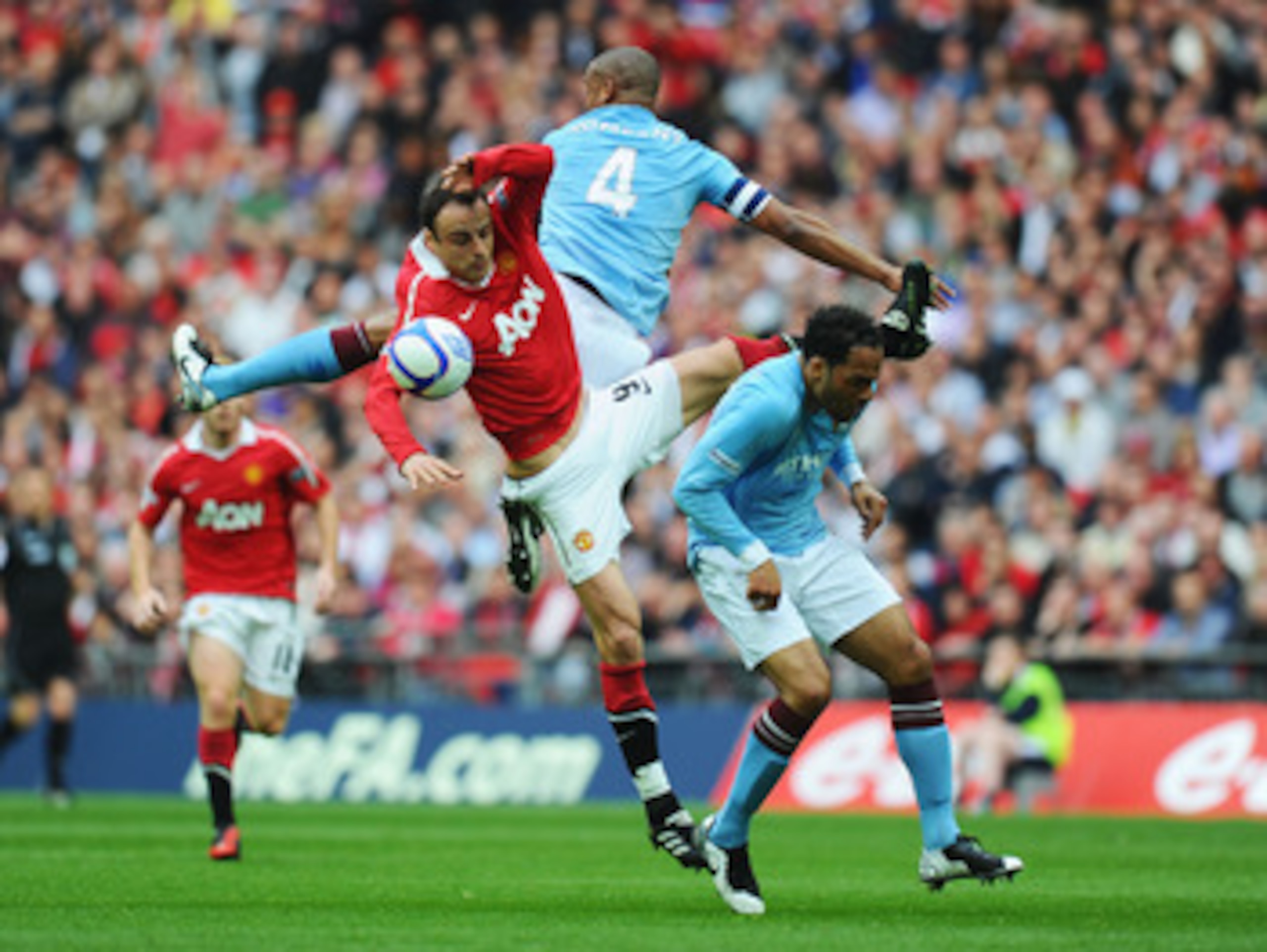 LONDON, ENGLAND - APRIL 16: Dimitar Berbatov of Manchester United goes up for the ball with Pablo Zabaleta and Joleon Lescott of Manchester City during the FA Cup sponsored by E.ON semi final match between Manchester City and Manchester United at Wembley