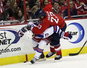 WASHINGTON, DC - APRIL 13: Scott Hannan #23 of the Washington Capitals hits Brandon Dubinsky #17 of the New York Rangers in Game One of the Eastern Conference Quarterfinals during the 2011 NHL Stanley Cup Playoffs at Verizon Center on April 13, 2011 in W WASHINGTON, DC - APRIL 13: Scott Hannan #23 of the Washington Capitals hits Brandon Dubinsky #17 of the New York Rangers in Game One of the Eastern Conference Quarterfinals during the 2011 NHL Stanley Cup Playoffs at Verizon Center on April 13, 2011 in W