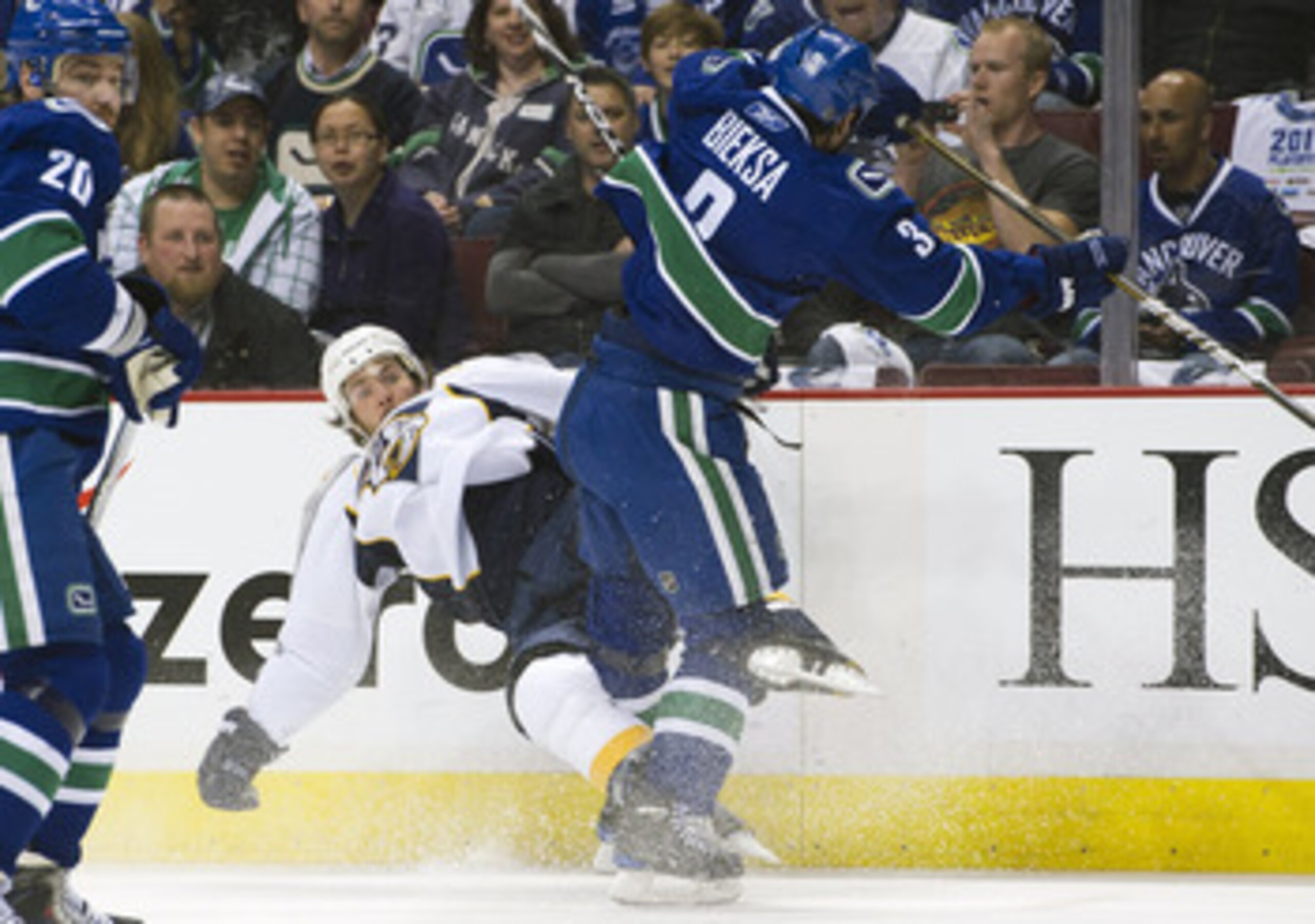VANCOUVER, CANADA - APRIL 28: Kevin Bieksa #3 of the Vancouver Canucks knocks Mike Fisher #12 of the Nashville Predators down onto the ice during the first period in Game One of the Western Conference Semifinals during the 2011 NHL Stanley Cup Playoffs on