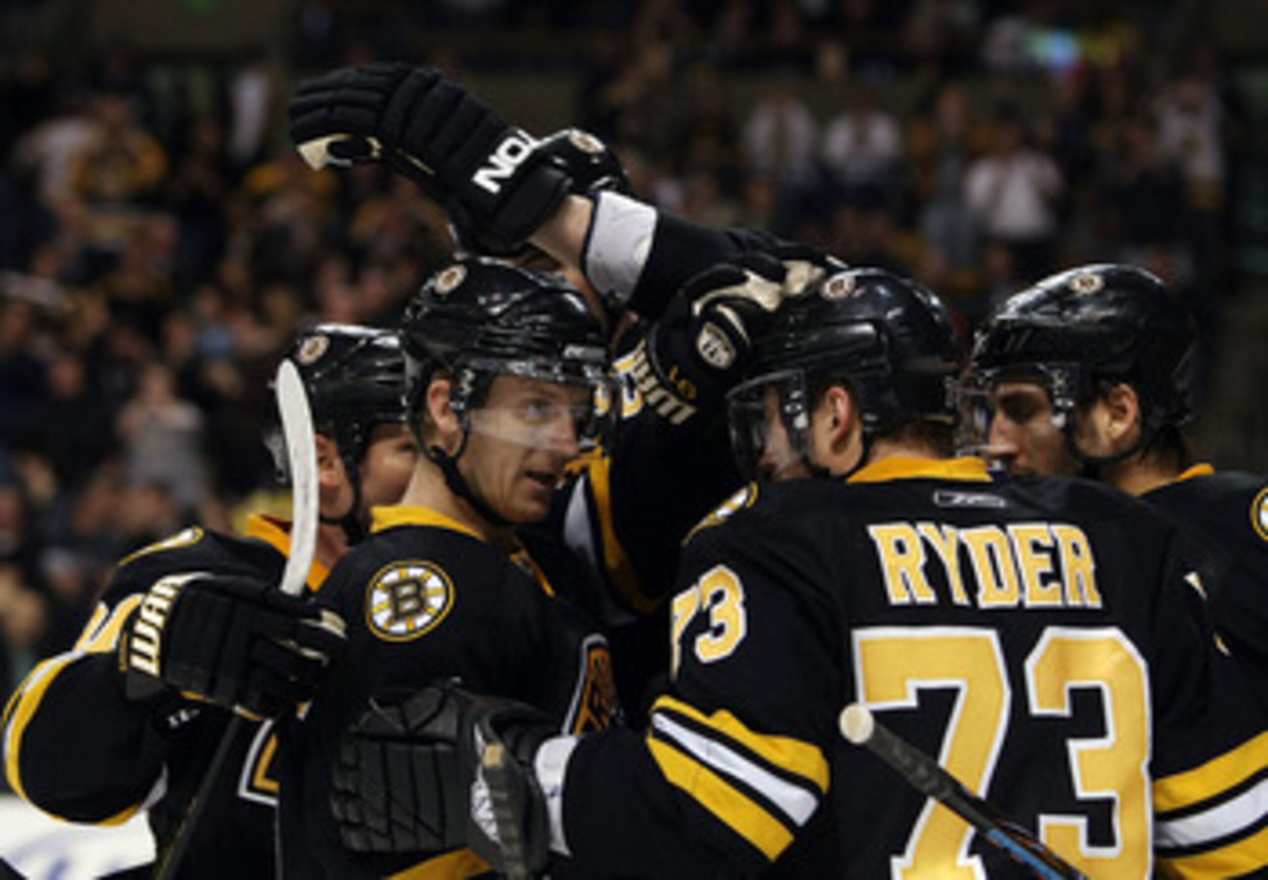 BOSTON - FEBRUARY 24:  Michael Ryder #73 of the Boston Bruins is congratulated by teammates P.J. Axelsson #11, Patrice Bergeron #37 and Marc Savard #91 after Ryder scored a goal in the third period against the Florida Panthers on February 24, 2009 at the 