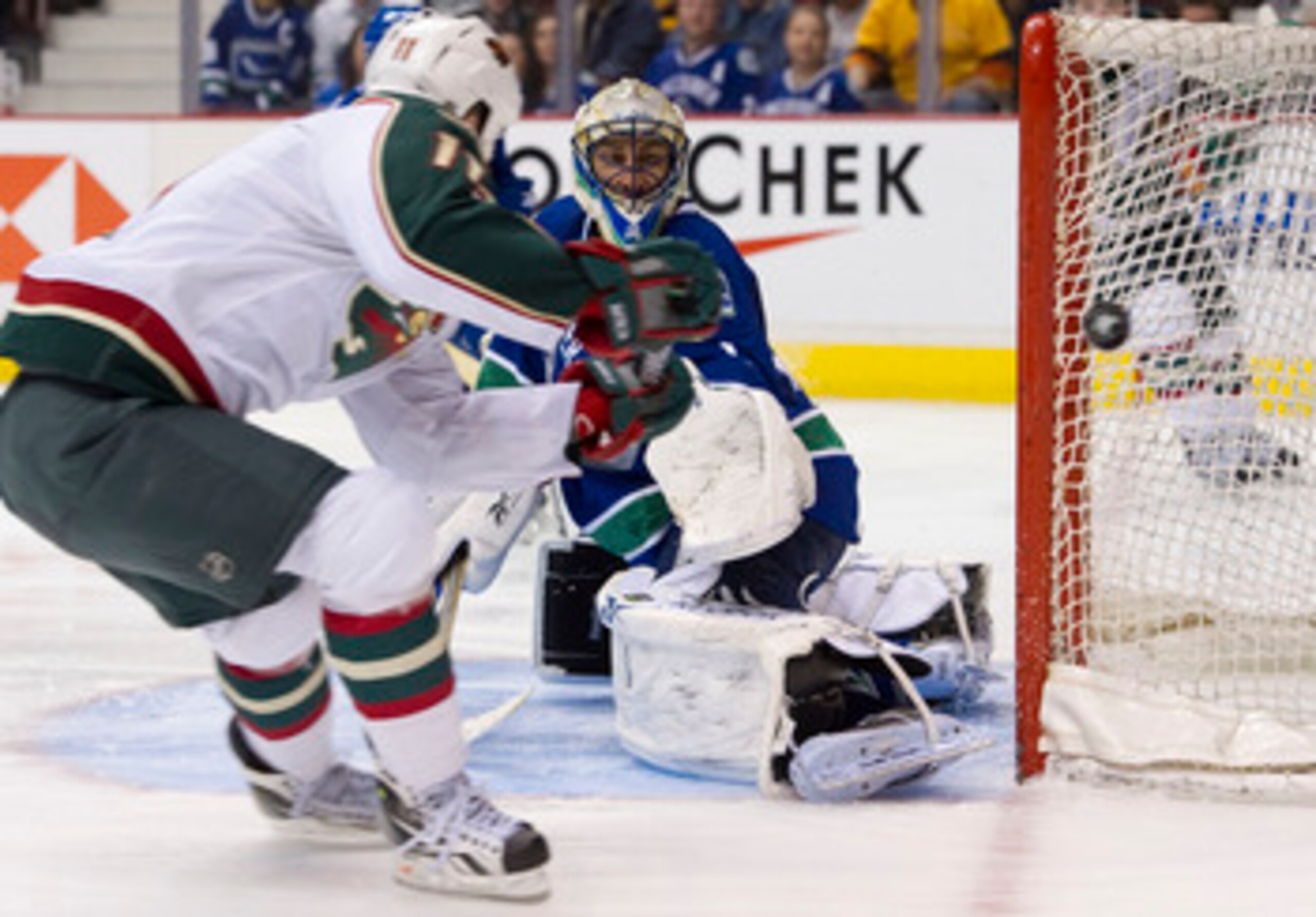 VANCOUVER, CANADA - MARCH 14: Goalie Roberto Luongo #1 of the Vancouver Canucks watches John Madden #11 of the Minnesota Wild shot go wide of the net during the third period in NHL action on March 14, 2011 at Rogers Arena in Vancouver, British Columbia, C