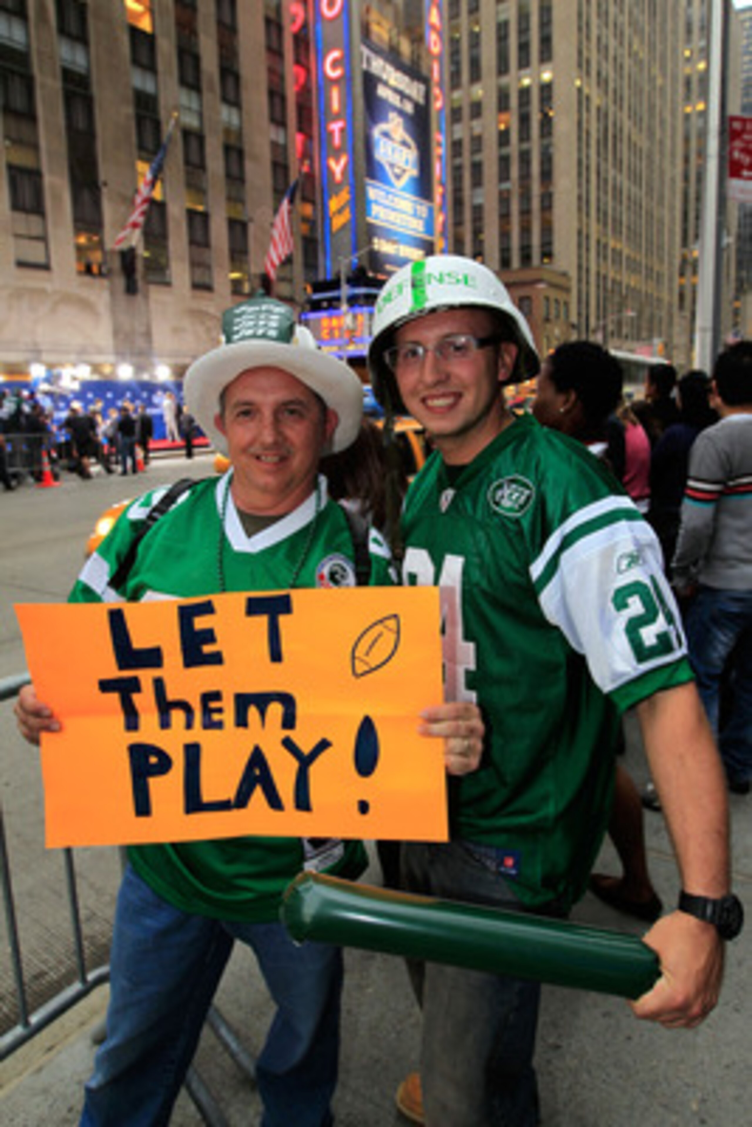 NEW YORK, NY - APRIL 28:  New York Jets fans Peter Merante Sr. and his son Peter Jr. hold up a sign which reads 'Let them play!' on the street outside the venue prior to the 2011 NFL Draft at Radio City Music Hall on April 28, 2011 in New York City.  (Pho