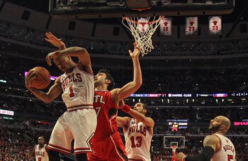 CHICAGO, IL - MAY 02: Derrick Rose #1 of the Chicago Bulls grabs a rebound in front of Zaza Puchulia #27 of the Atlanta Hawks in Game One of the Eastern Conference Semifinals in the 2011 NBA Playoffs at the United Center on May 2, 2011 in Chicago, Illinoi