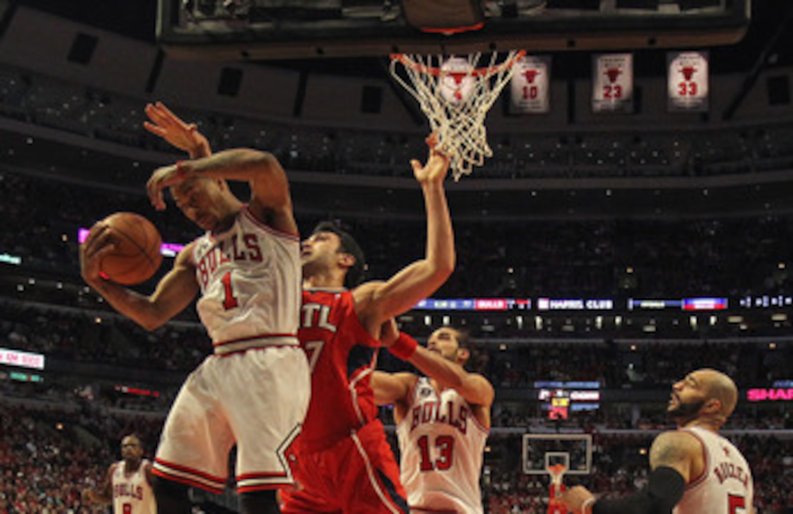 CHICAGO, IL - MAY 02: Derrick Rose #1 of the Chicago Bulls grabs a rebound in front of Zaza Puchulia #27 of the Atlanta Hawks in Game One of the Eastern Conference Semifinals in the 2011 NBA Playoffs at the United Center on May 2, 2011 in Chicago, Illinoi