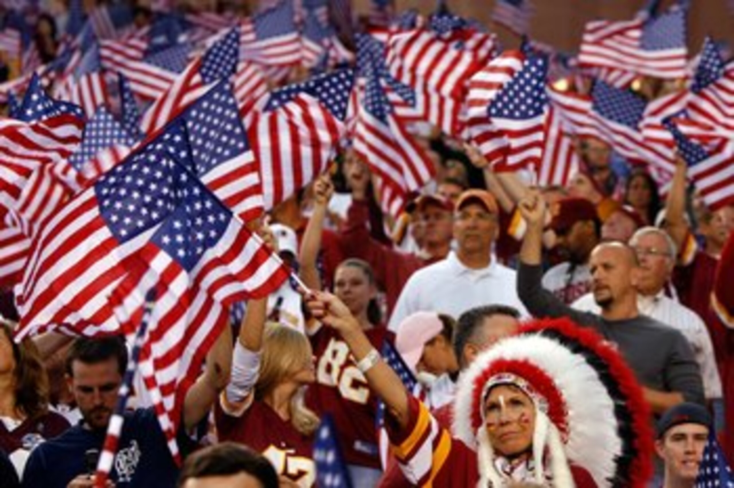 LANDOVER, MD - SEPTEMBER 11:  Fans wave flags before a game between the Minnesota Vikings and the Washington Redskins during the first Monday Night Football game of the season on September 11, 2006 at FedEx Field in Landover, Maryland.  (Photo by Win McNa