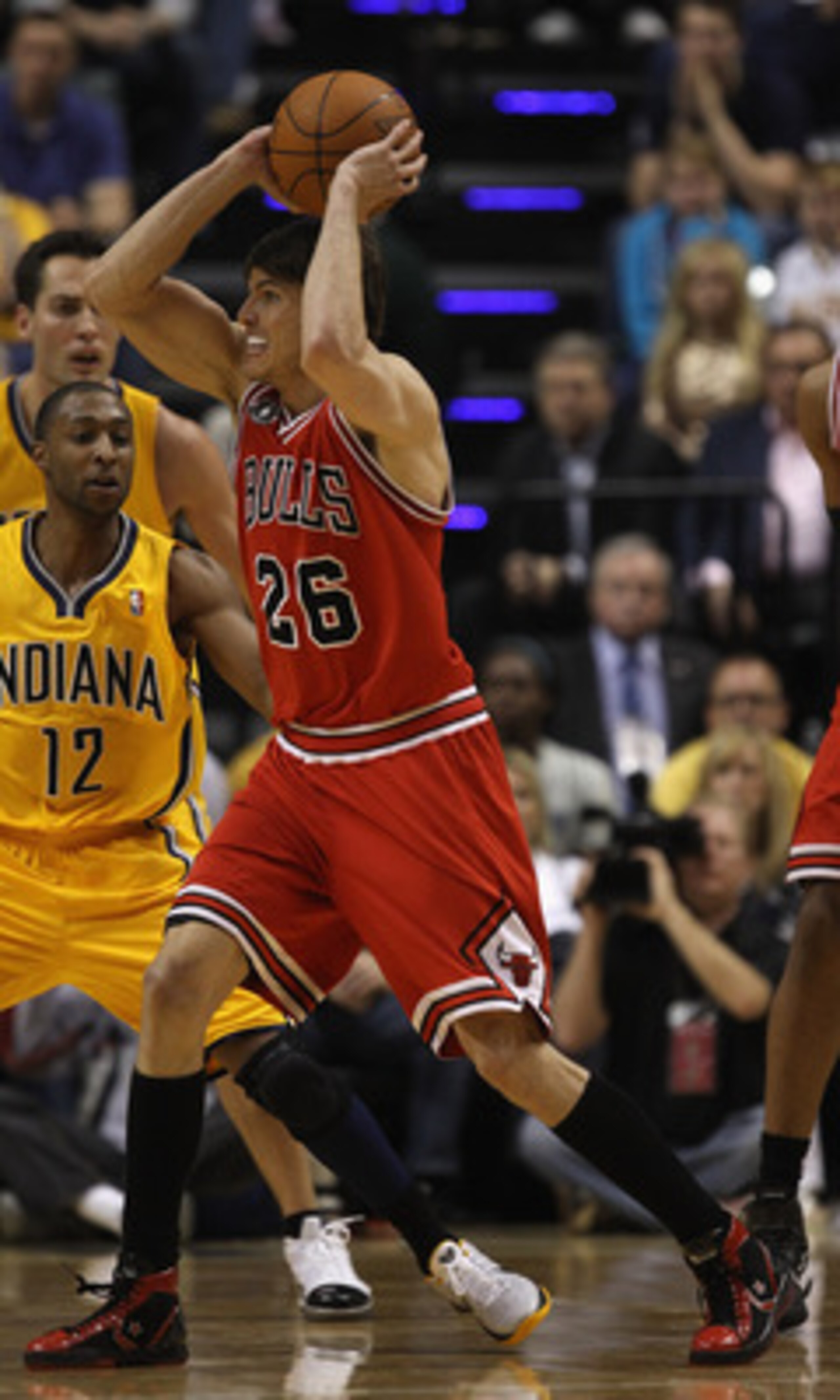 INDIANAPOLIS, IN - APRIL 23: Kyle Korver #26 of the Chicago Bulls passes the ball under pressure from A.J. Price #12 of the Indiana Pacers in Game Four of the Eastern Conference Quarterfinals in the 2011 NBA Playoffs at Conseco Fieldhouse on April 23, 201