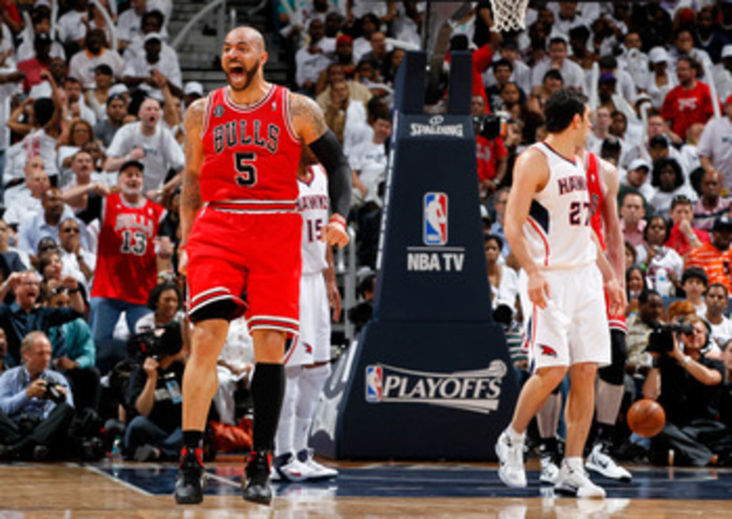 ATLANTA, GA - MAY 12:  Carlos Boozer #5 of the Chicago Bulls reacts after Omer Asik #3 scored a basket and a foul against the Atlanta Hawks in Game Six of the Eastern Conference Semifinals in the 2011 NBA Playoffs at Phillips Arena on May 12, 2011 in Atla
