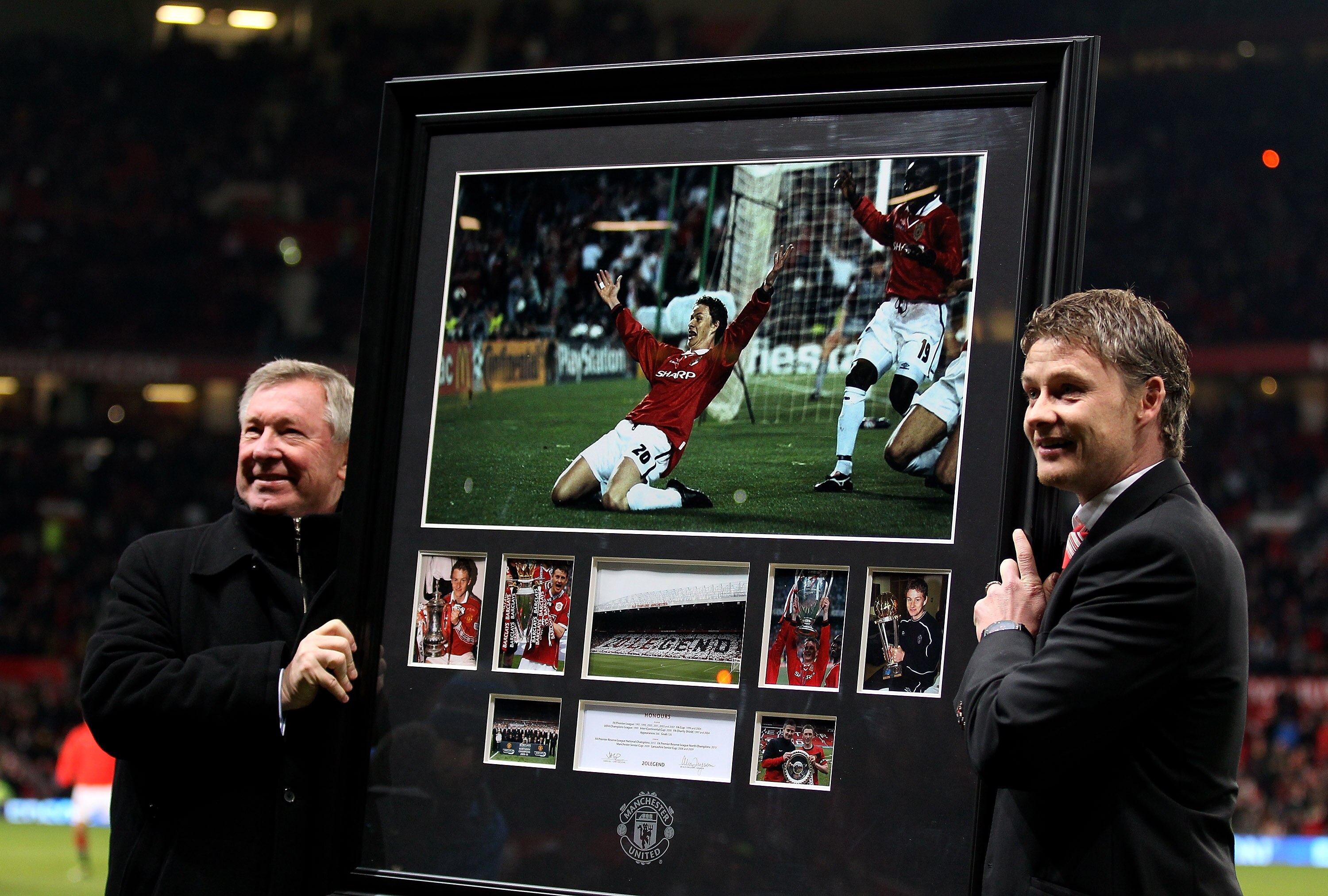 MANCHESTER, ENGLAND - DECEMBER 13:  Manchester United Manager Sir Alex Ferguson presents Ole Gunnar Solskjaer with a print of his winning goal celebration from the 1999 Champions League Final prior to the Barclays Premier League match between Manchester U