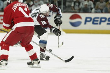 DENVER - MAY 25: Chris Drury #18 of the Colorado Avalanche dumps the puck against the Detroit Red Wings in the second period of game four of the Western Conference Finals during the NHL Stanley Cup Playoffs at the Pepsi Center in Denver, Colorado, on May