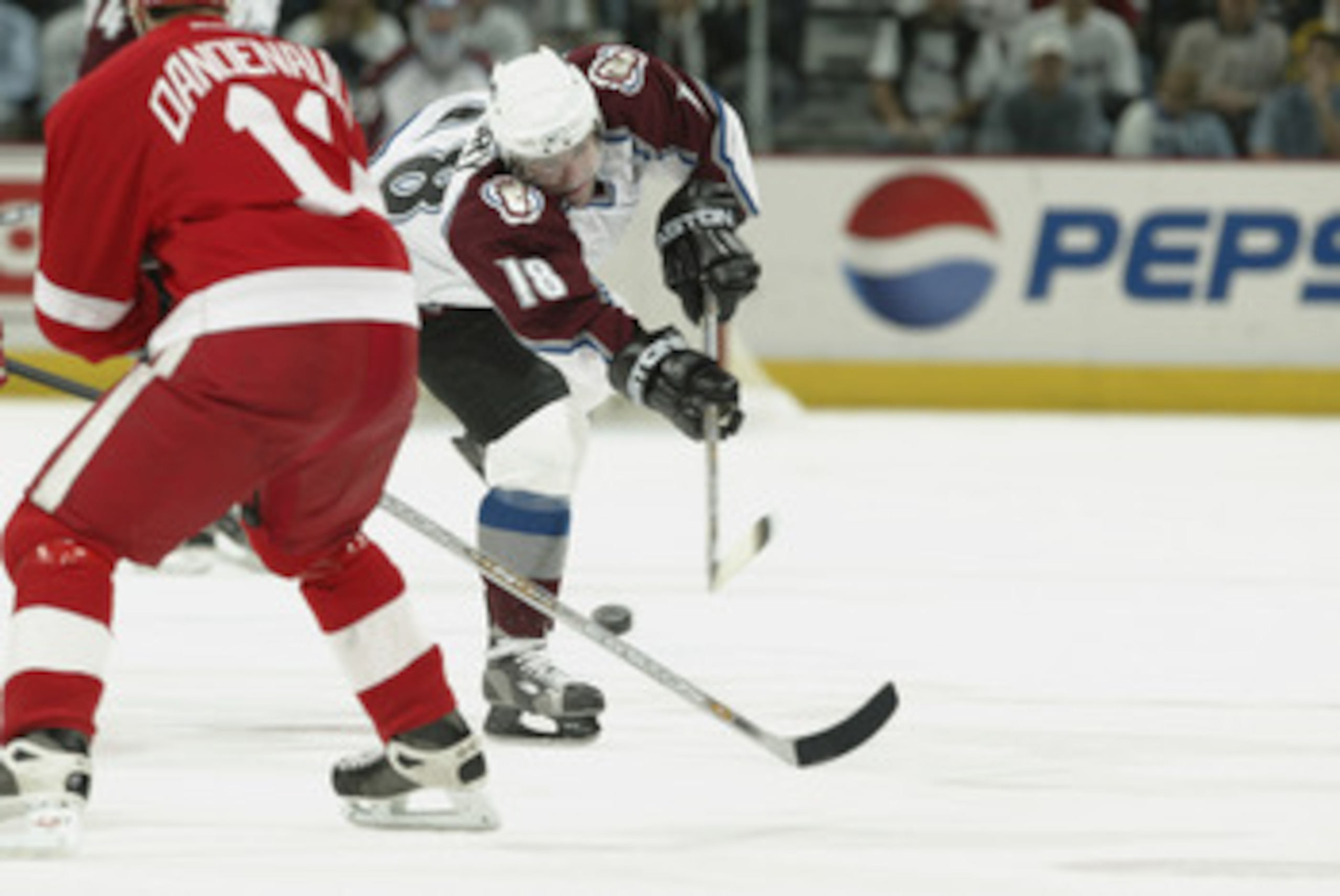 DENVER - MAY 25: Chris Drury #18 of the Colorado Avalanche dumps the puck against the Detroit Red Wings in the second period of game four of the Western Conference Finals during the NHL Stanley Cup Playoffs at the Pepsi Center in Denver, Colorado, on May