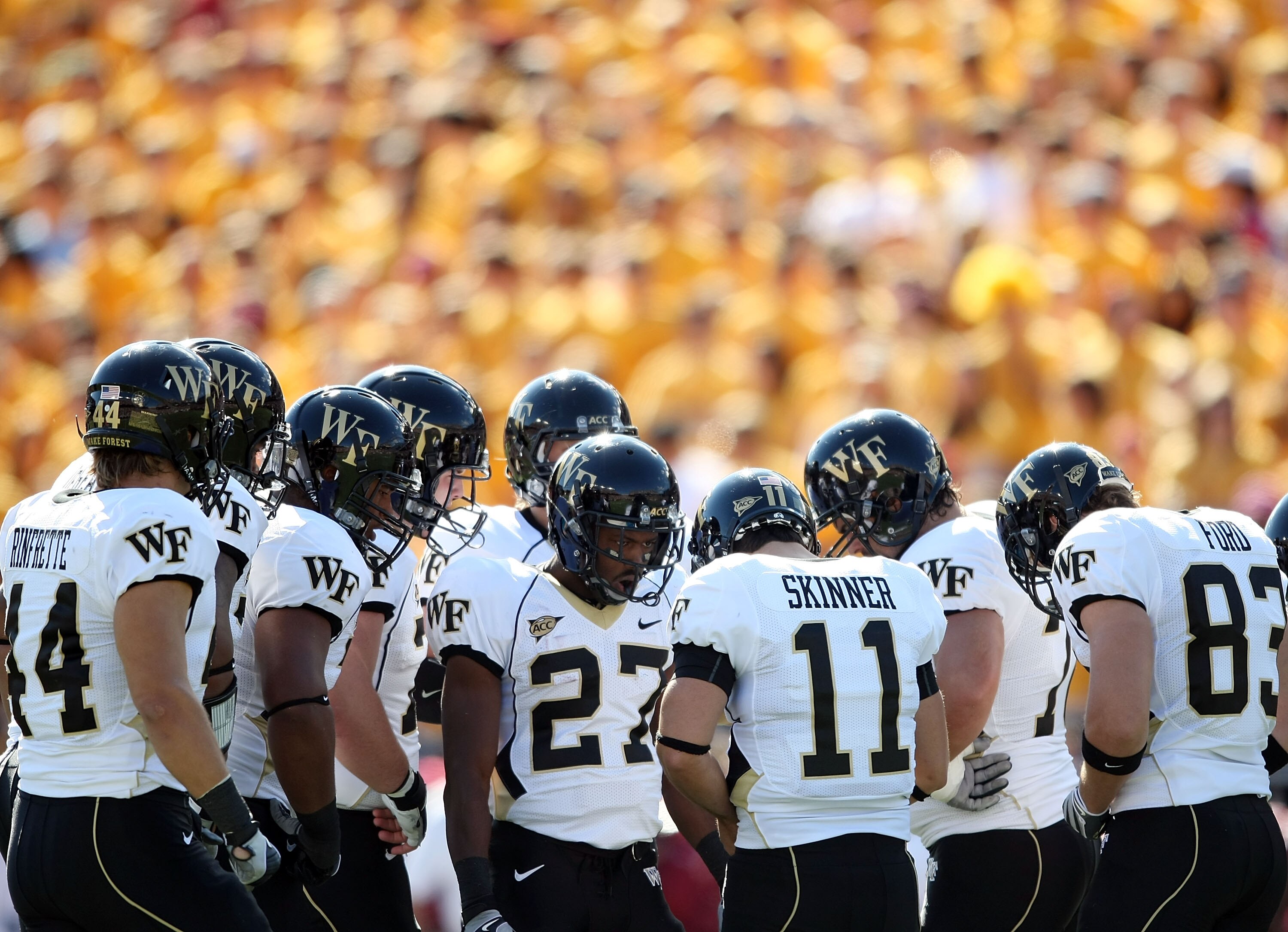 CHESTNUT HILL, MA - SEPTEMBER 26:  Quarterback Riley Skinner #11 of the Wake Forest Demon Deacons calls the play in the huddle in the first half against the Boston College Eagles on September 26, 2009 at Alumni Stadium in Chestnut Hill, Massachusetts.  (P