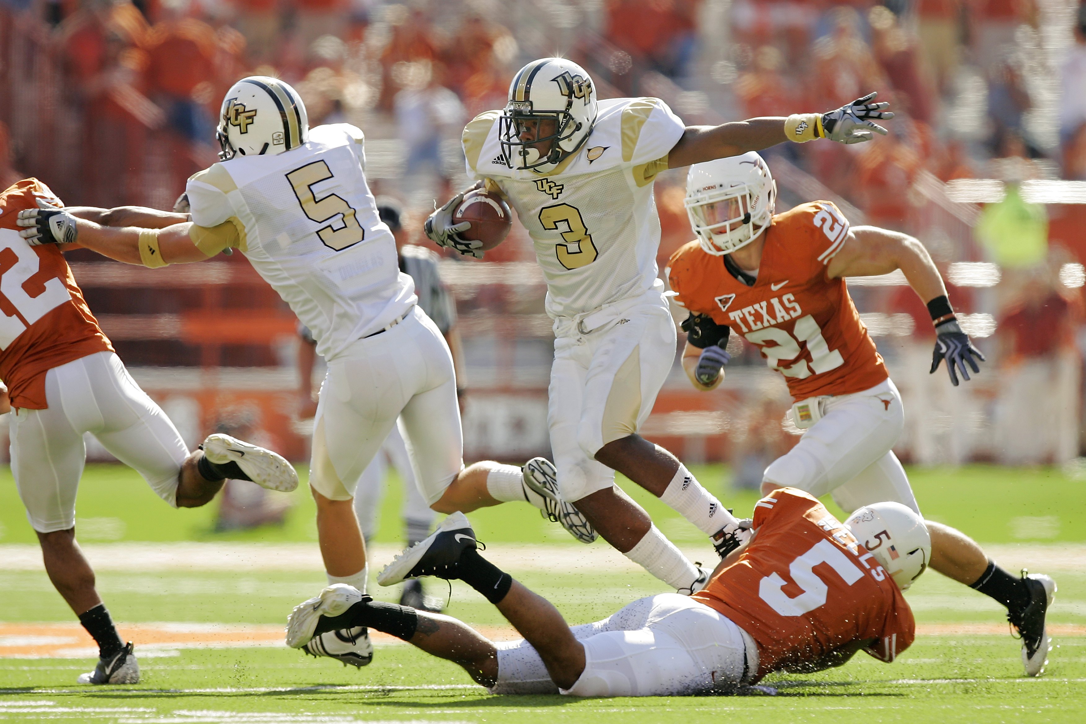 AUSTIN, TX - NOVEMBER 07:  Safety Ben Wells #5 of the Texas Longhorns tackles wide receiver A.J. Guyton #3 of the UCF Knights on November 7, 2009 at Darrell K Royal - Texas Memorial Stadium in Austin, Texas.  Texas won 35-3.  (Photo by Brian Bahr/Getty Im