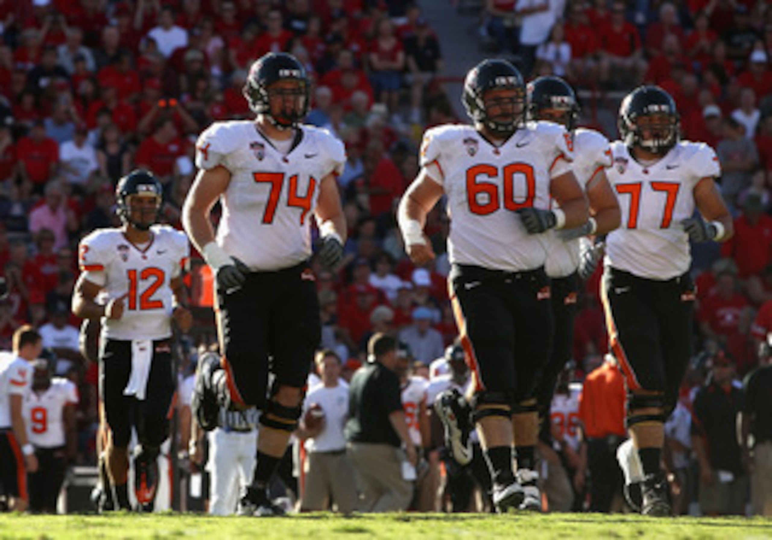TUCSON, AZ - OCTOBER 09:  (L-R) Ryan Katz #12, Burke Ellis #74, Alex Linnenkohl #60 and Michael Philipp #77 of the Oregon State Beavers during the college football game against the Arizona Wildcats at Arizona Stadium on October 9, 2010 in Tucson, Arizona.