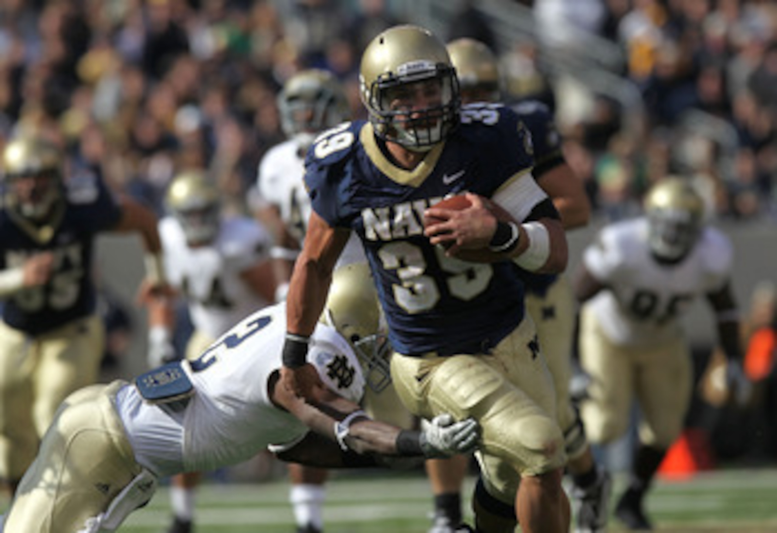 EAST RUTHERFORD, NJ - OCTOBER 23: Alexander Teich #39 of the Navy Midshipmen rushes past the tackle of Darrin Walls #2 of the Notre Dame Fighting Irish at New Meadowlands Stadium on October 23, 2010 in East Rutherford, New Jersey.  (Photo by Nick Laham/Ge