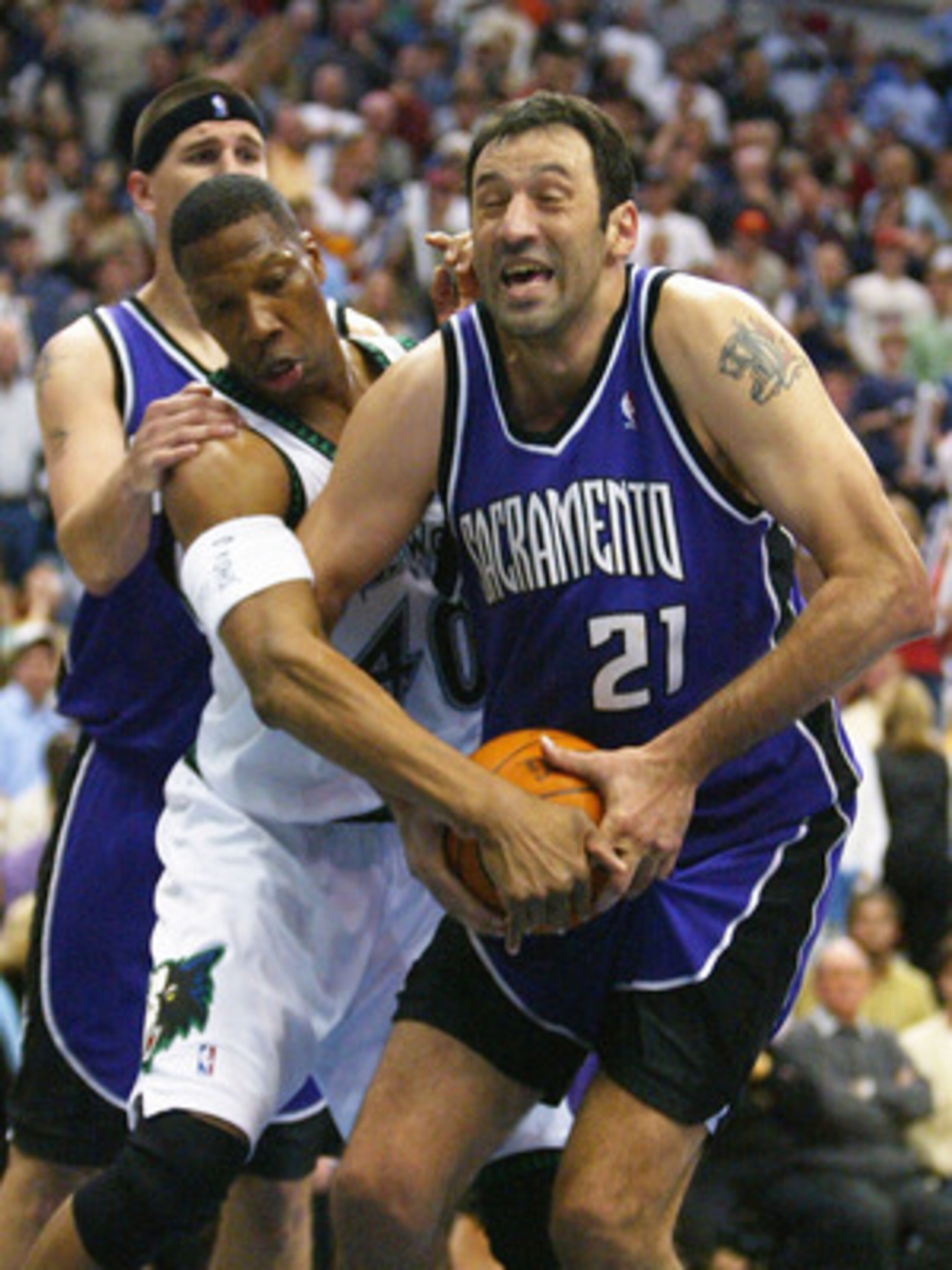 MINNEAPOLIS - MAY 14:  Vlade Divac #21 of  the Sacramento Kings is fouled by Ervin Johnson #40 of the Minnesota Timberwolves in Game five of the Western Conference Semifinals of the 2004 NBA Playoffs on May 14, 2004 at the Target Center  in Minneapolis, M